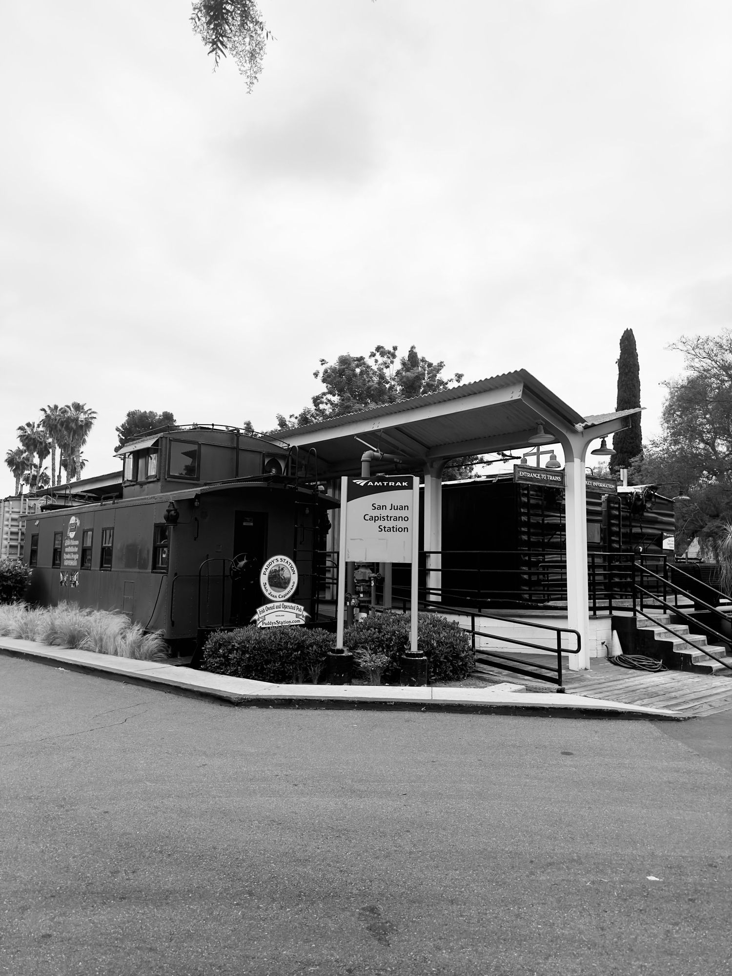 Black and white photo series showing the exterior of a modern commercial building with clean lines and glass windows.