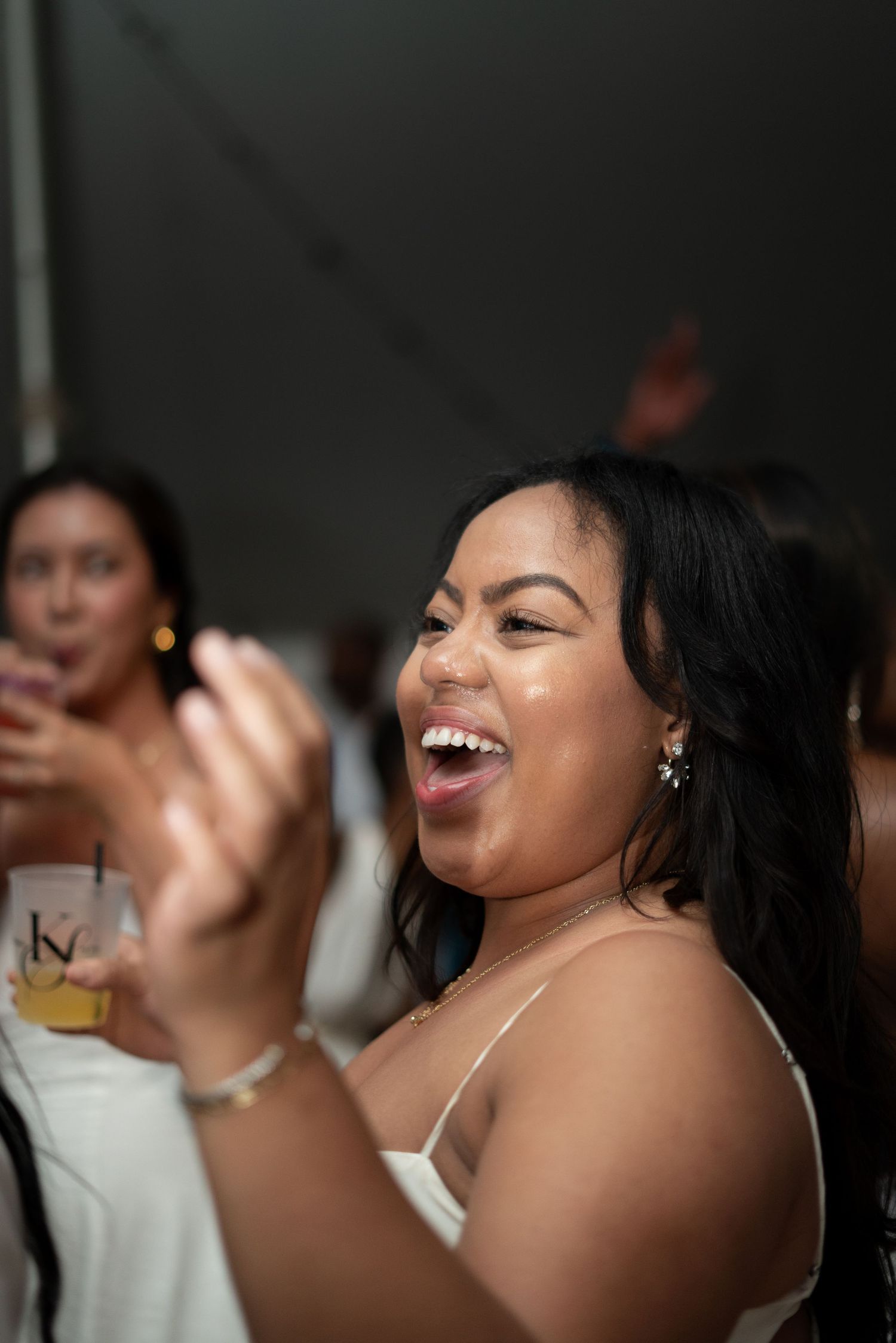 People enjoying drinks and laughing together at what appears to be a celebration or party.
