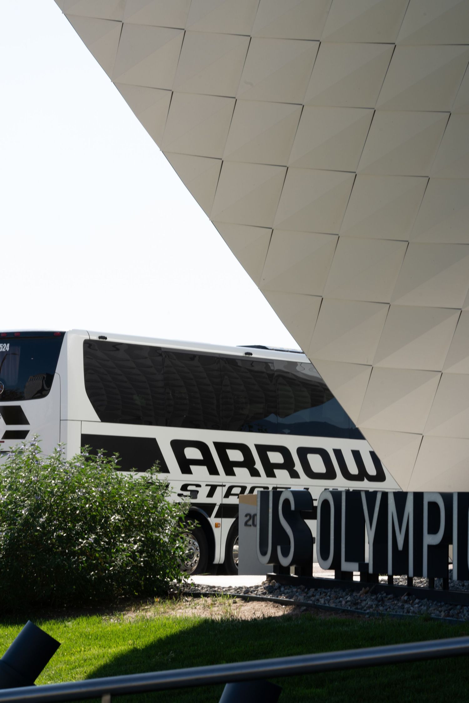 Modern architectural detail showing Arrow signage against a white geometric background.