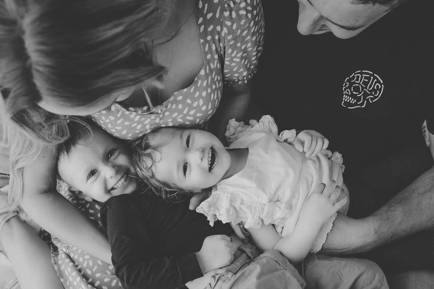 Black and white photo collage showing intimate family moments and candid interactions between parents and children.