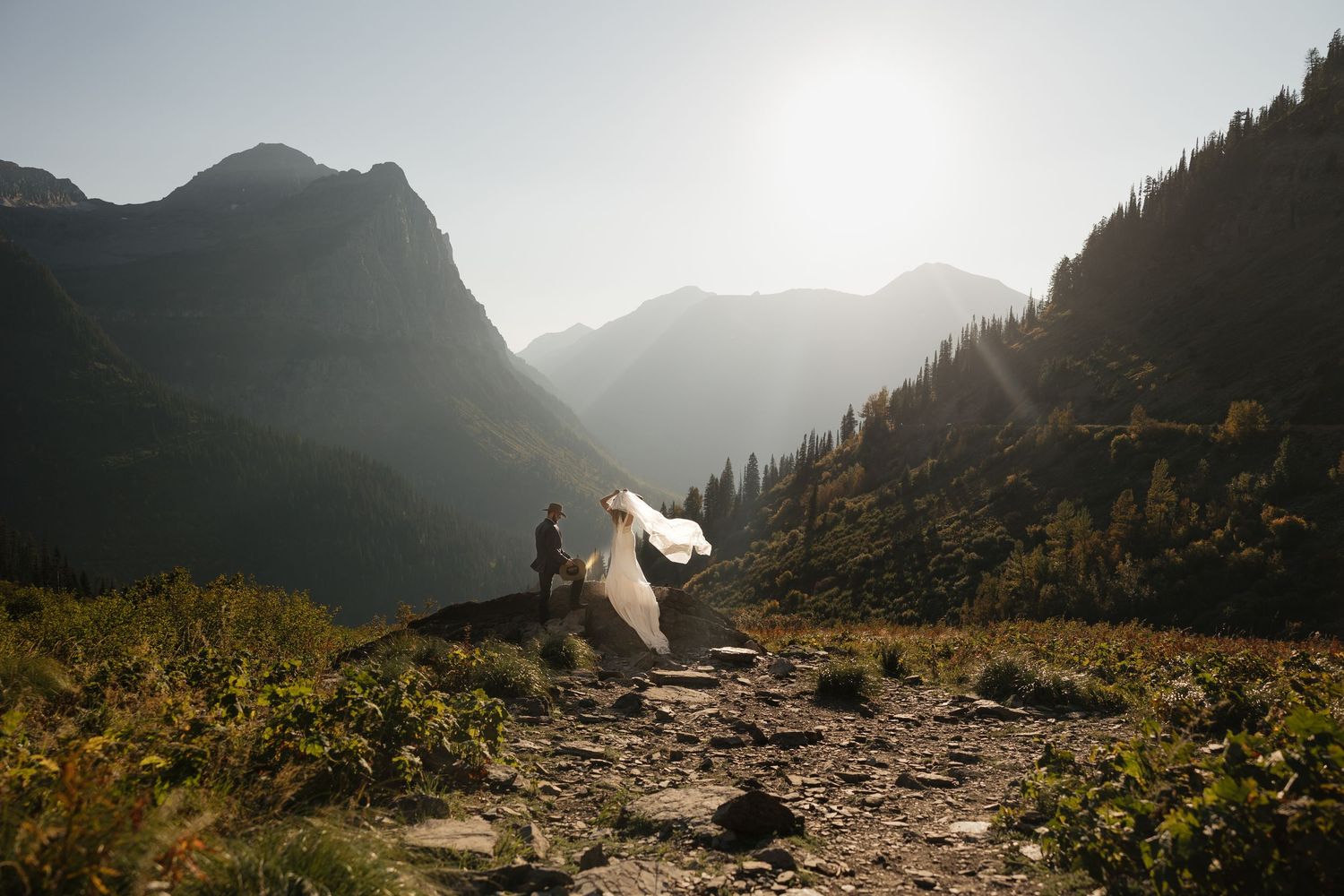 A series of mountain landscapes at sunset showing a rocky hiking trail winding through dramatic alpine scenery.