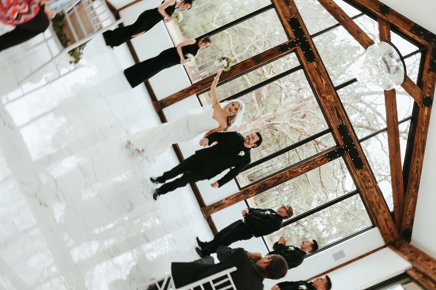 An artistic overhead view of students in dark uniforms walking down concrete stairs while casting long shadows.