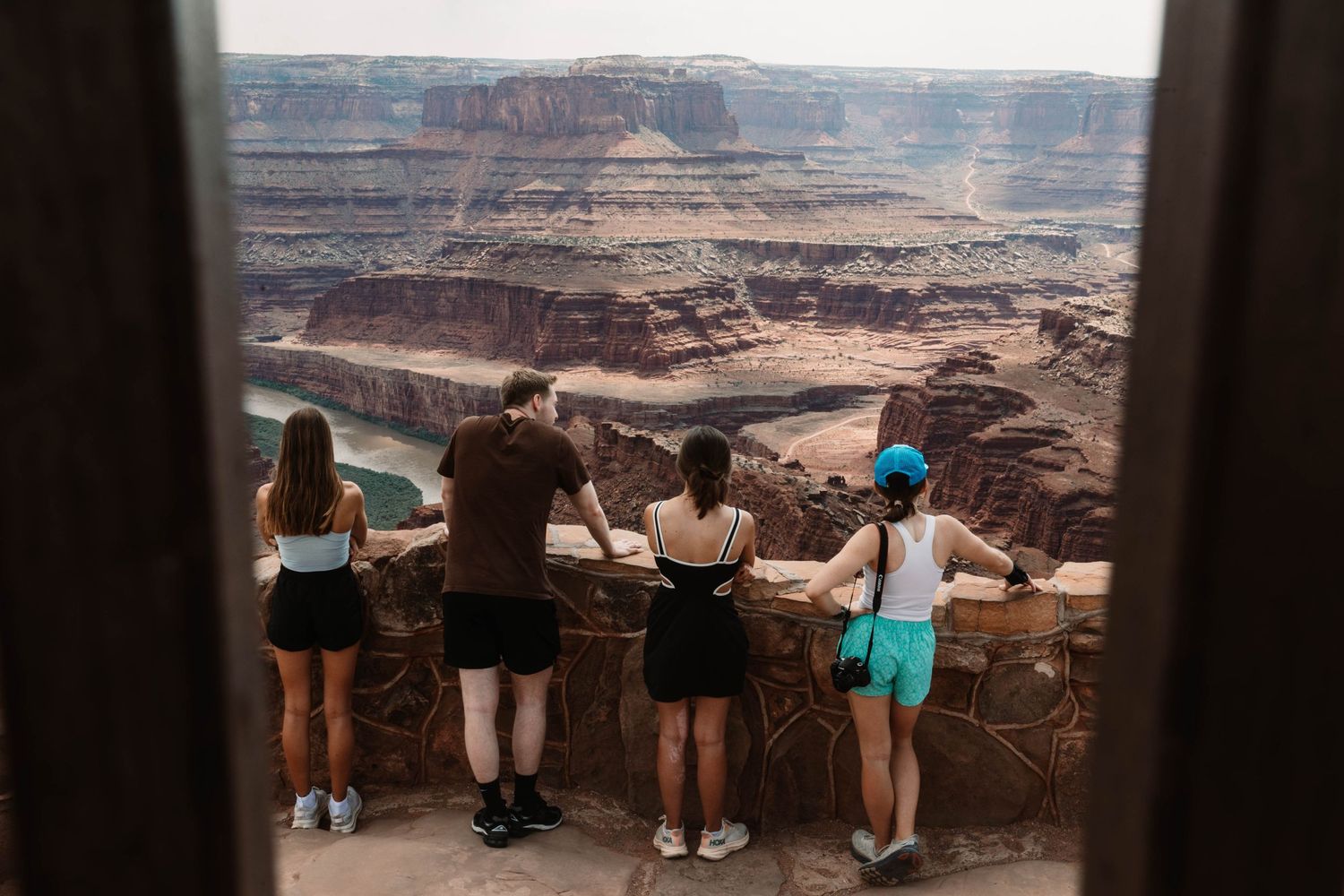 Tourists looking out over the vast landscape of Dead Horse Point State Park in Utah's Canyonlands.