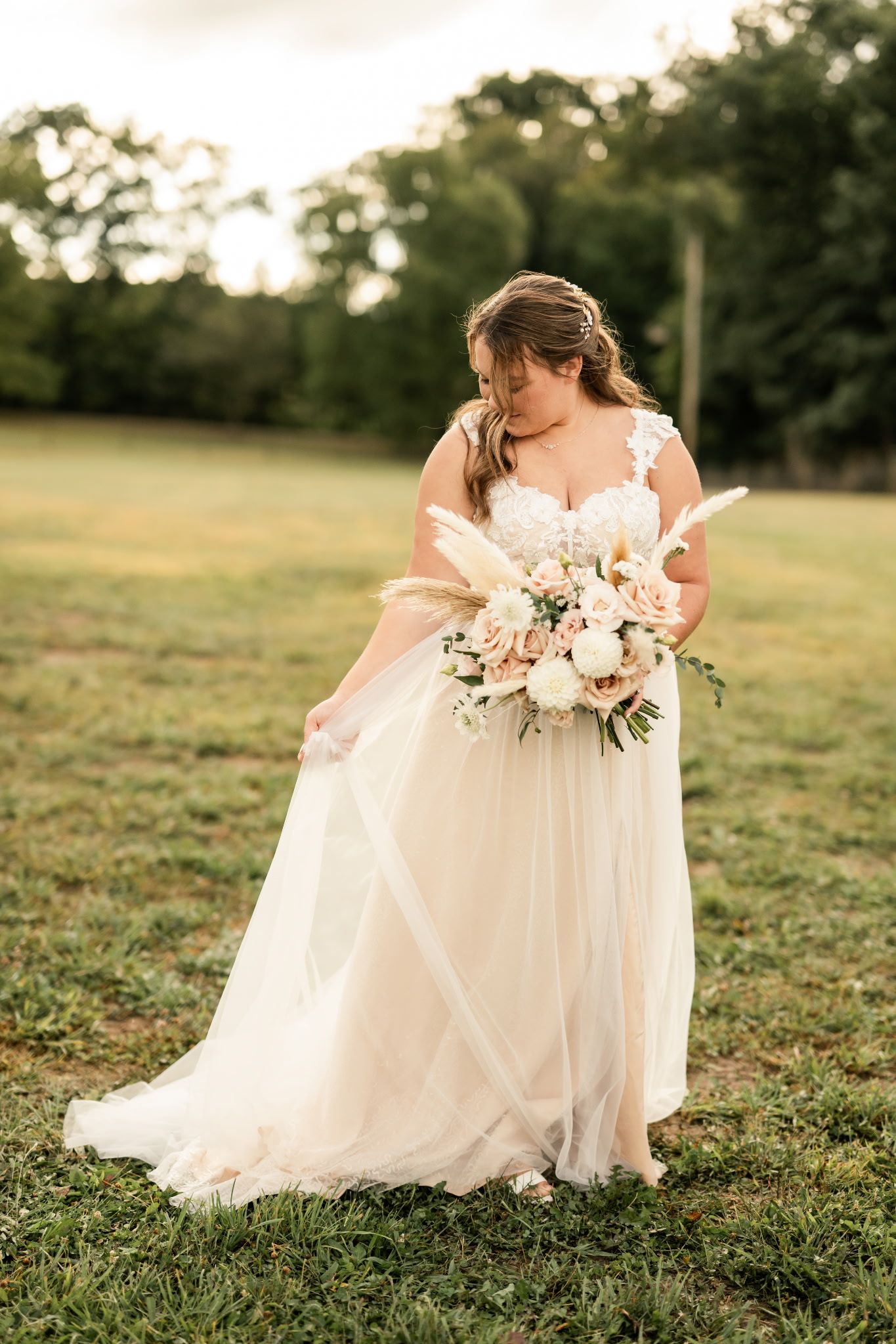 Ethereal bridal portrait with romantic bouquet in flowing white gown.