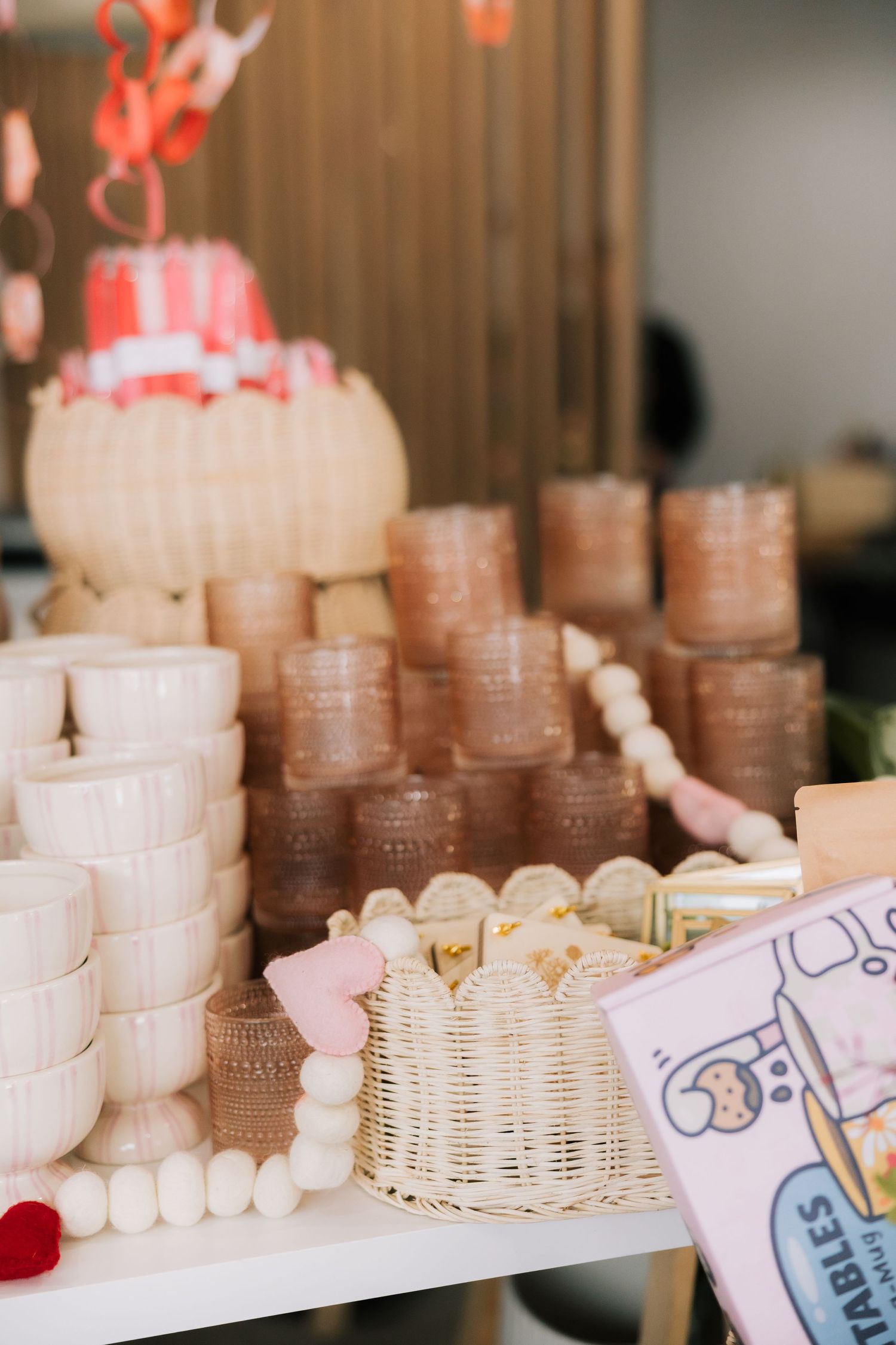Rows of stacked coins and paper money arranged on display with small decorative hearts.