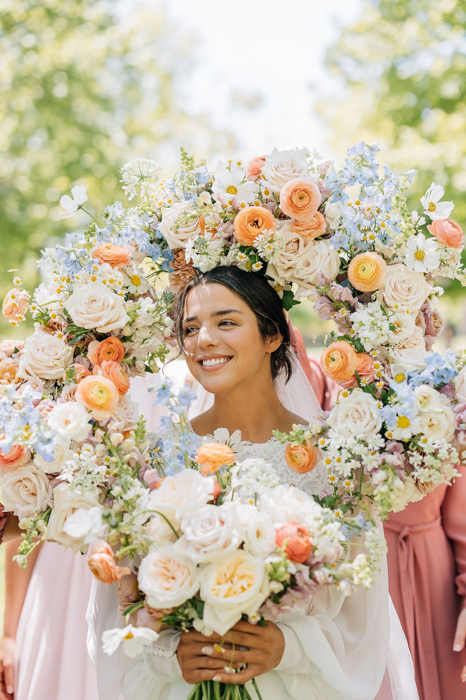 A beautiful floral arrangement of peach roses, white blooms and blue forget-me-nots creates a romantic spring garden aesthetic.
