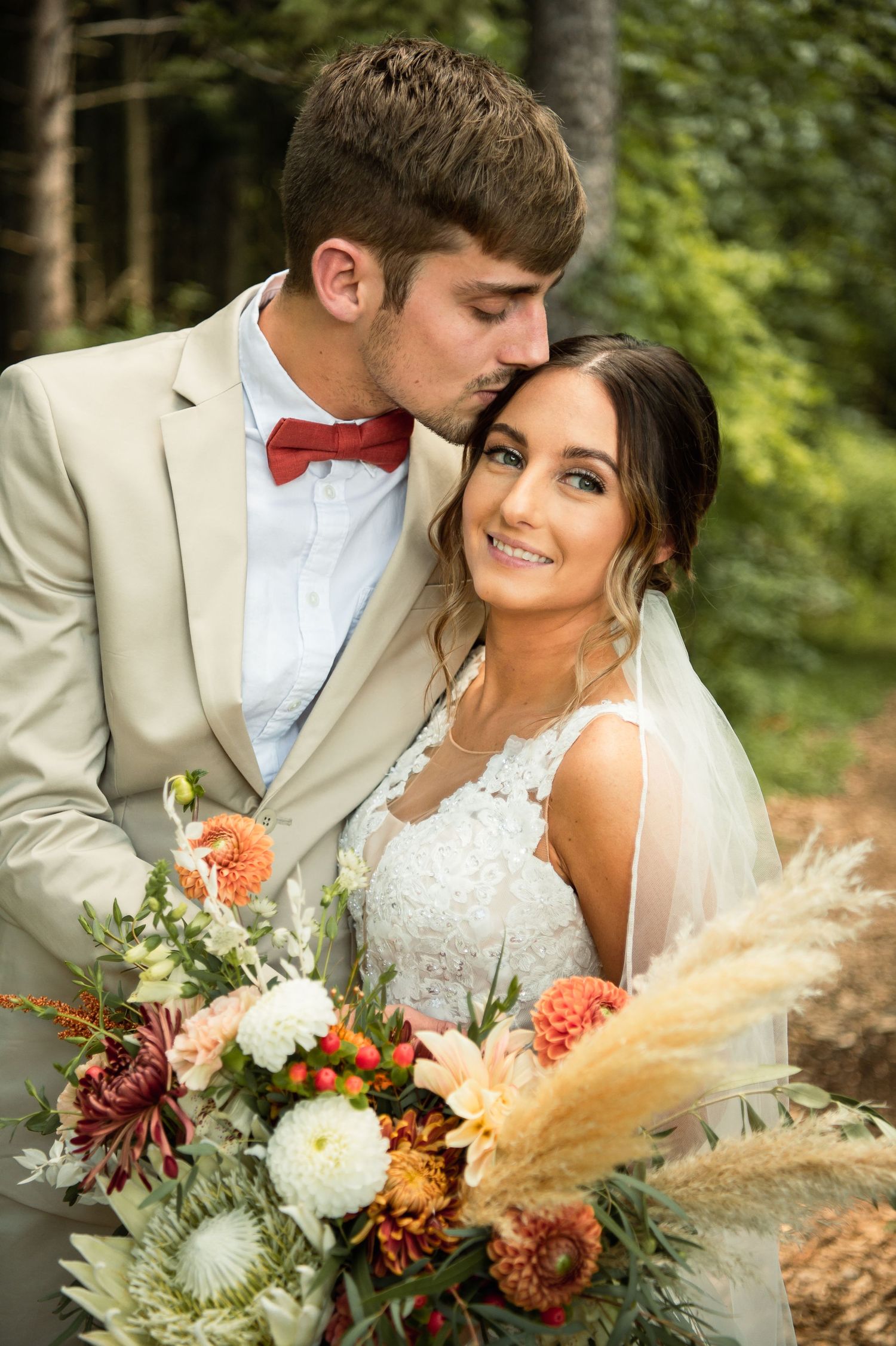 Romantic wedding portrait with boho-inspired bouquet featuring pampas grass and dahlias.