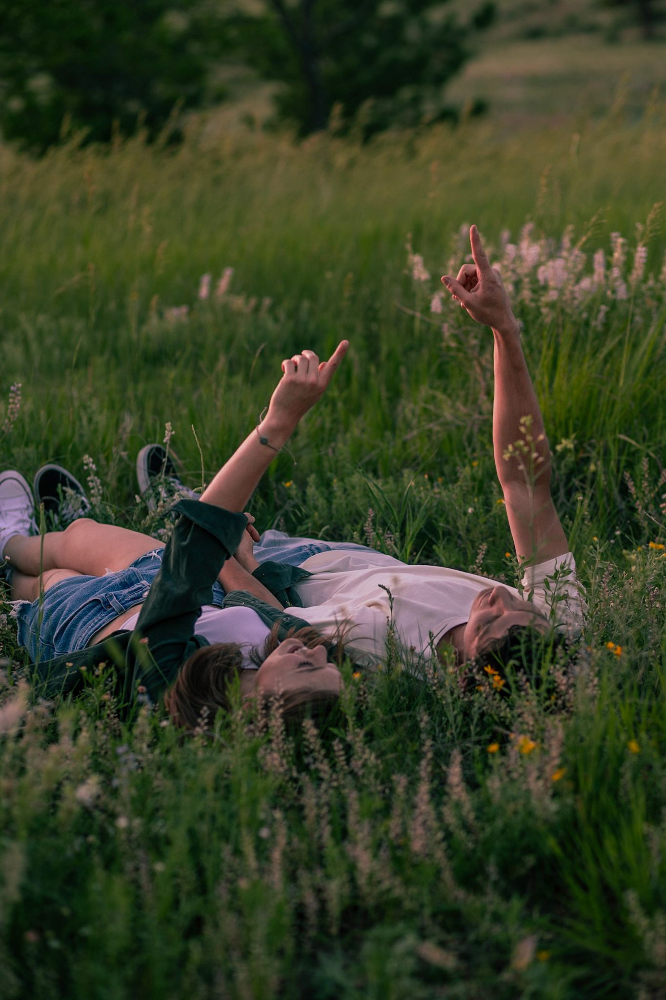 Couple embracing with the mountainous backdrop of Horsetooth Falls in Fort Collins, Colorado.