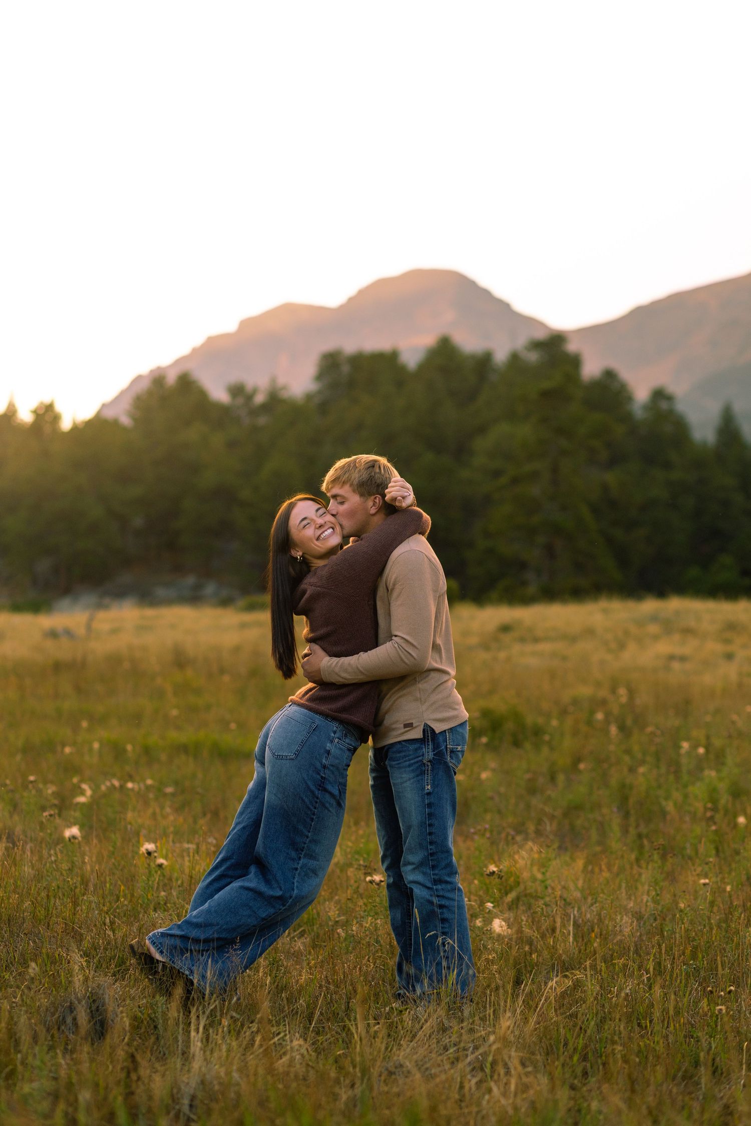Candid moment captured between couple at romantic setting in Rocky Mountain National Park | Colorado