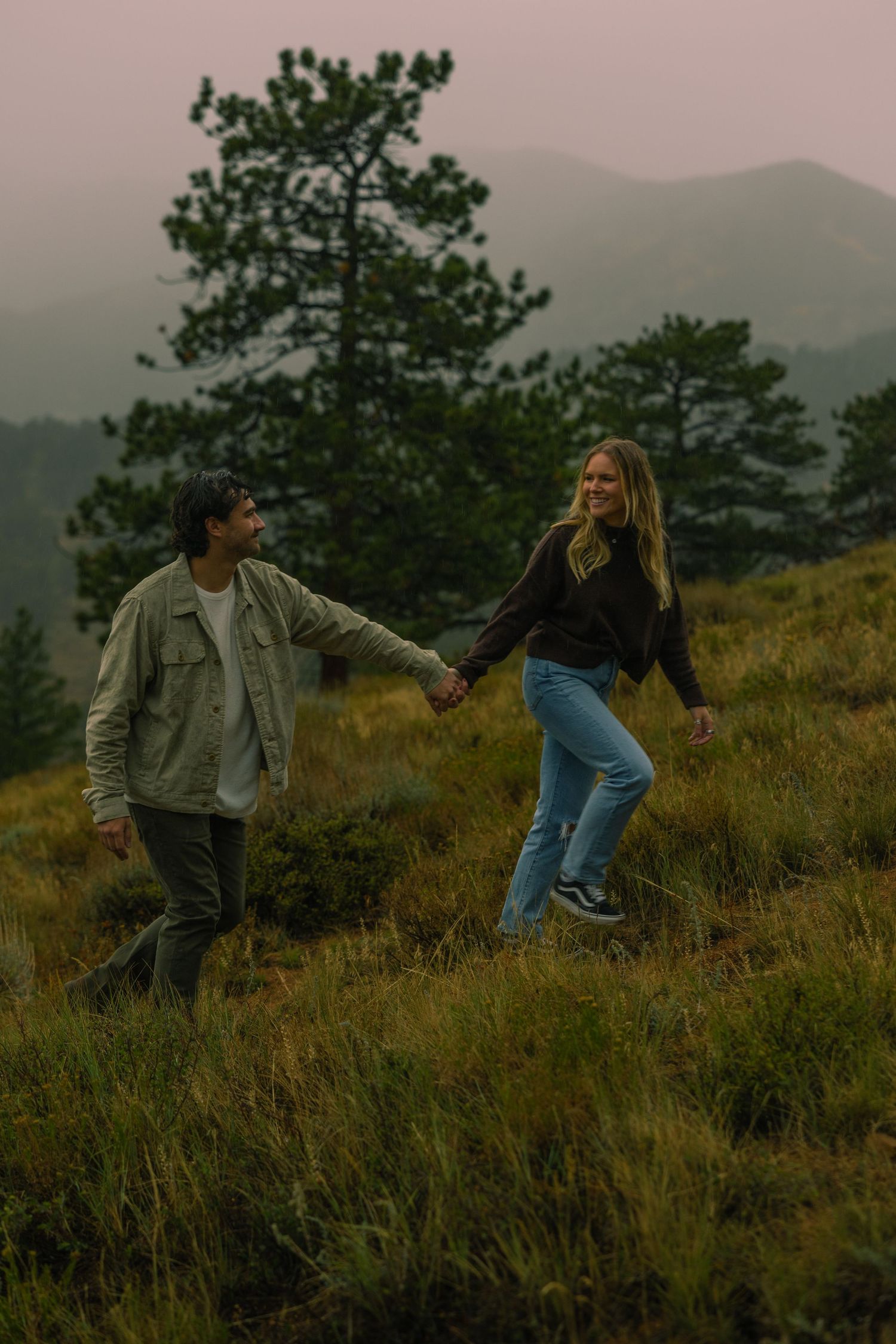 A couple exploring in the rain in the romantic setting of Rocky Mountain National Park, Colorado.