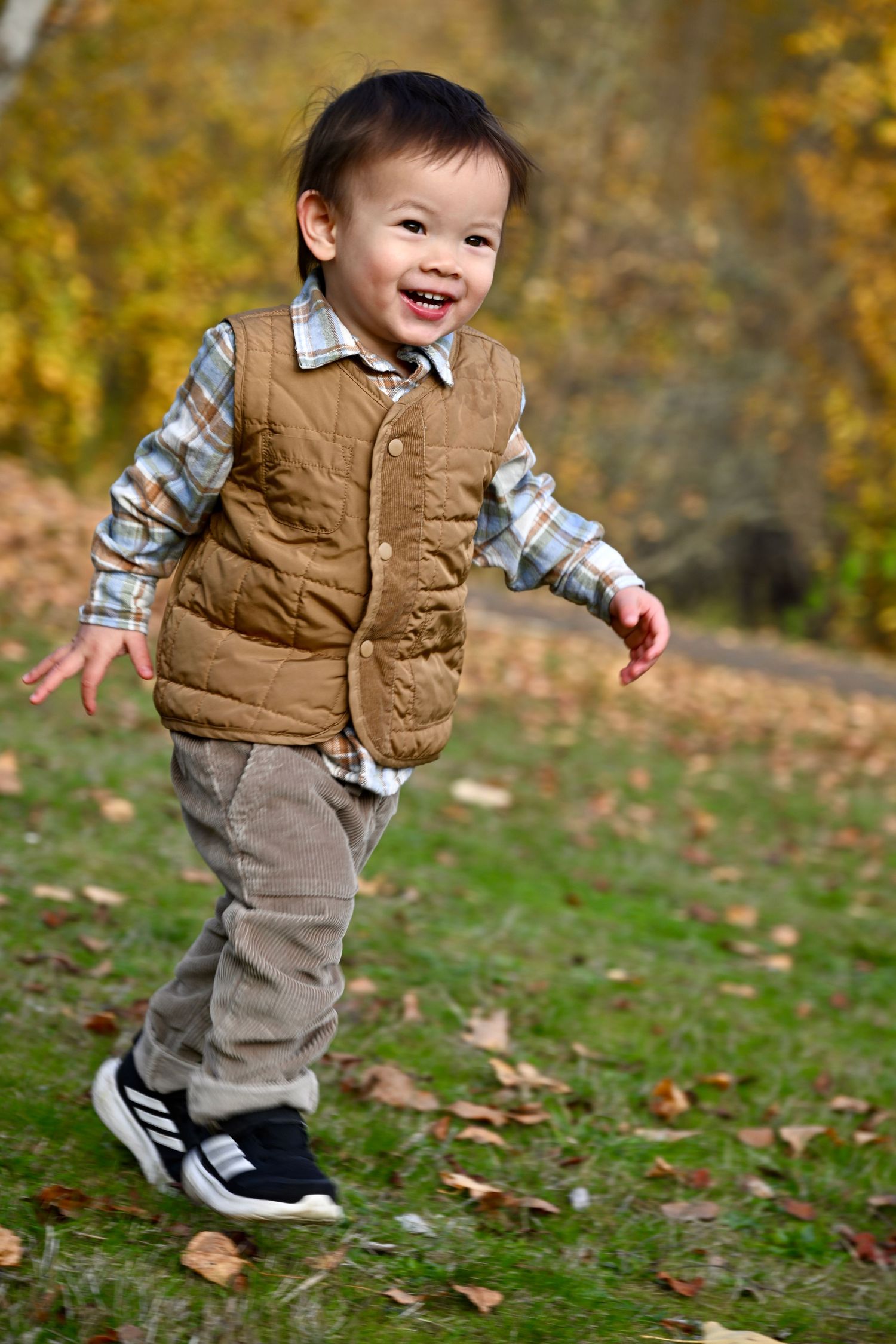 Family portrait session at Battle Point Park on Bainbridge Island, WA. Young boy running.
