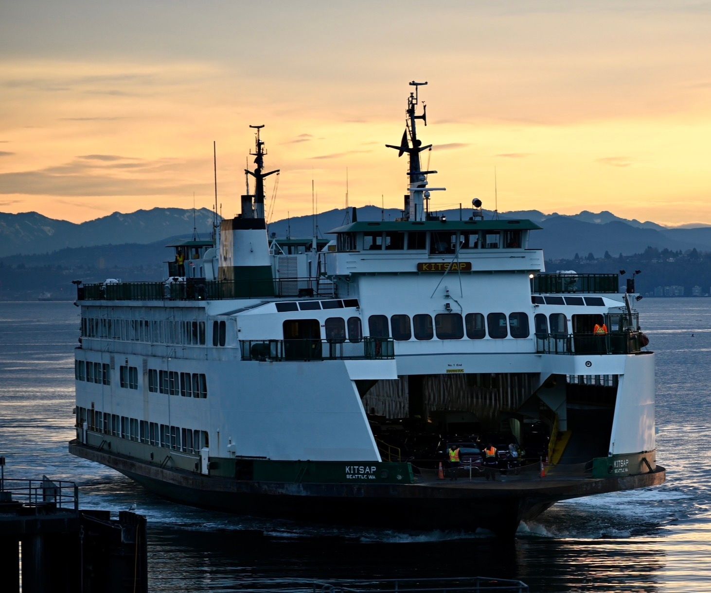 Landscape photo of Washington State Ferry sailing into Bainbridge Island terminal at Sunrise.