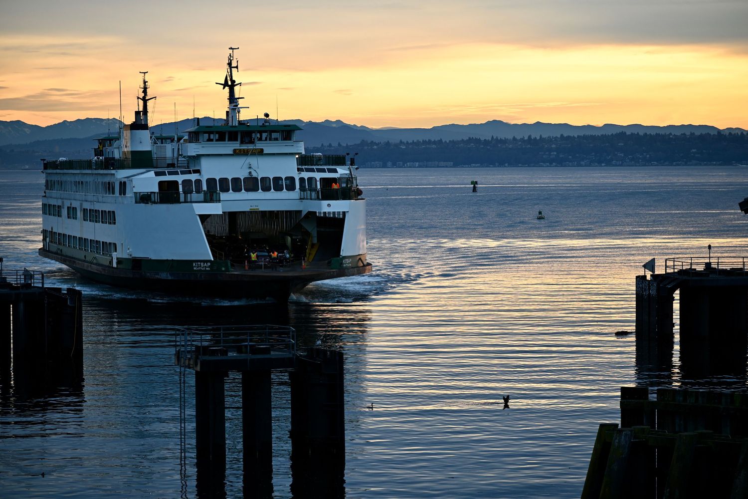Bainbridge Island family and commercial photography. Washington State Ferry sailing into Bainbridge Island terminal at Sunrise.