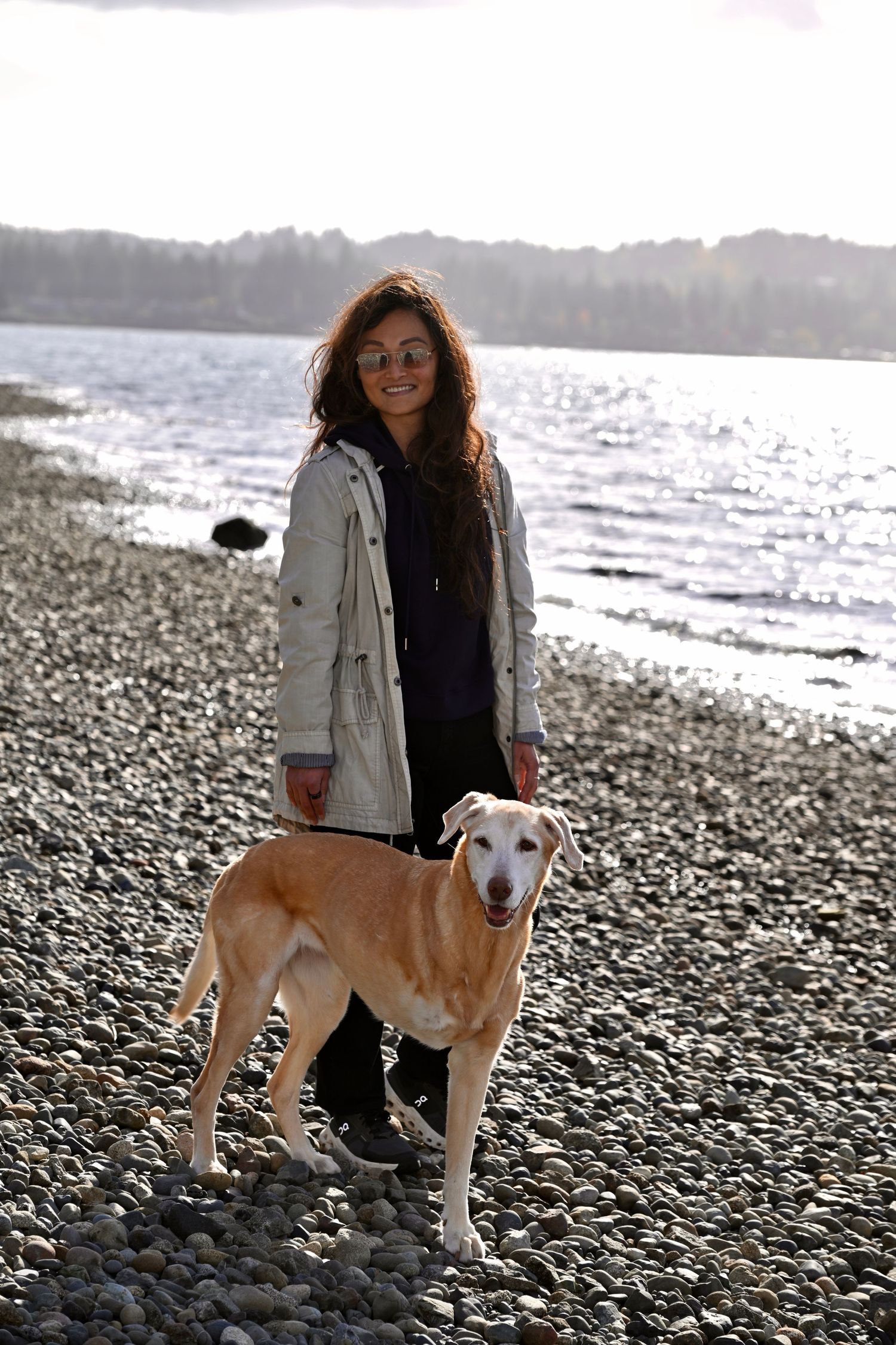 Family portrait session at Point White Pier on Bainbridge Island. WA. Ocean view with lady and her dog.