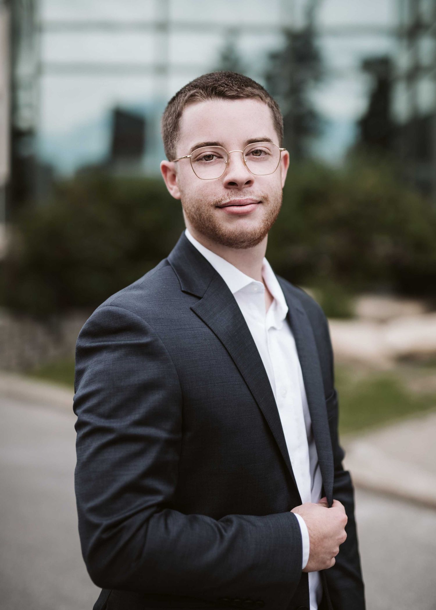Professional outdoor portraits of person in formal attire.