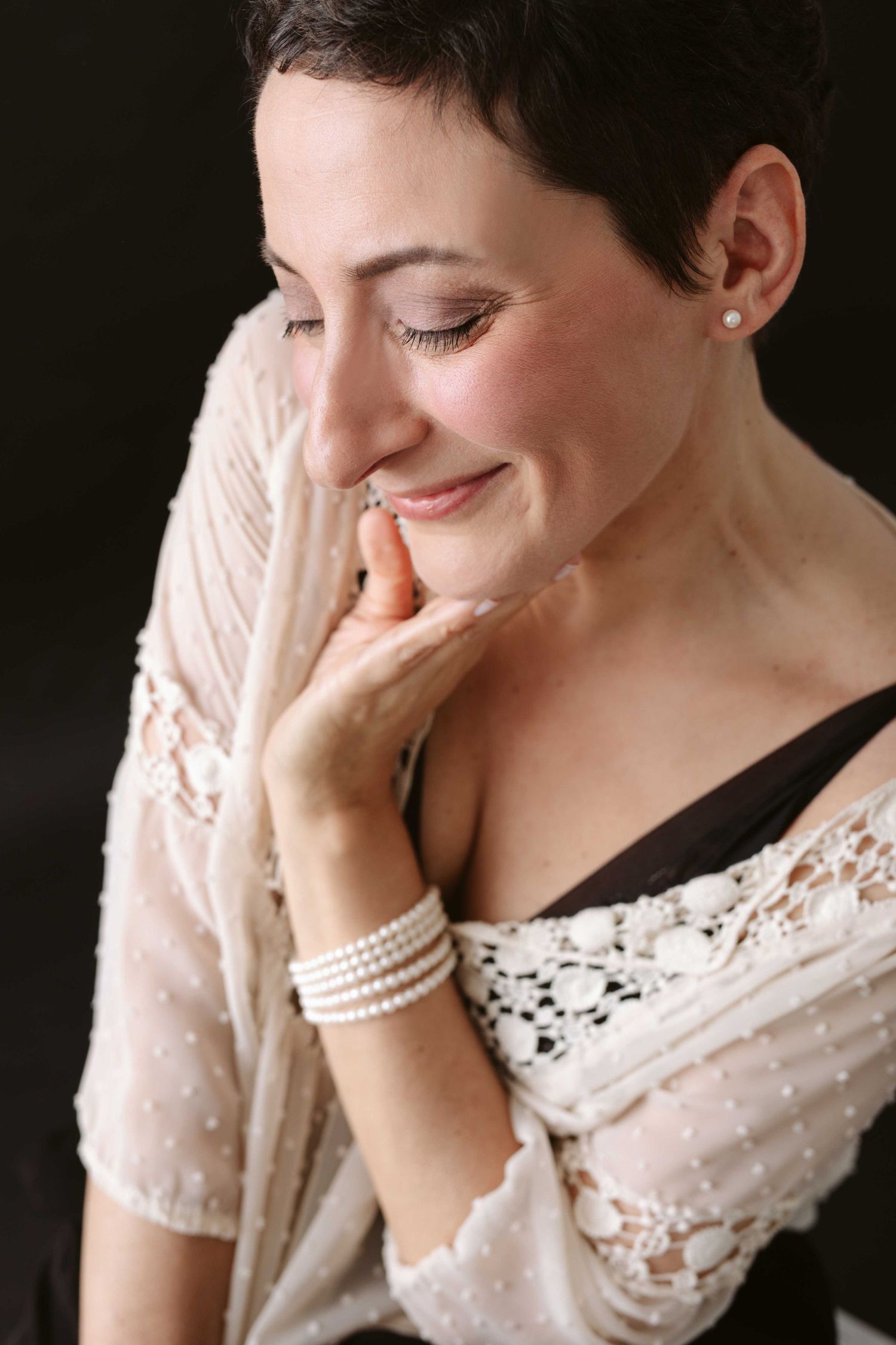 Portrait series showing expressions of joy and laughter while wearing a delicate white lace top.