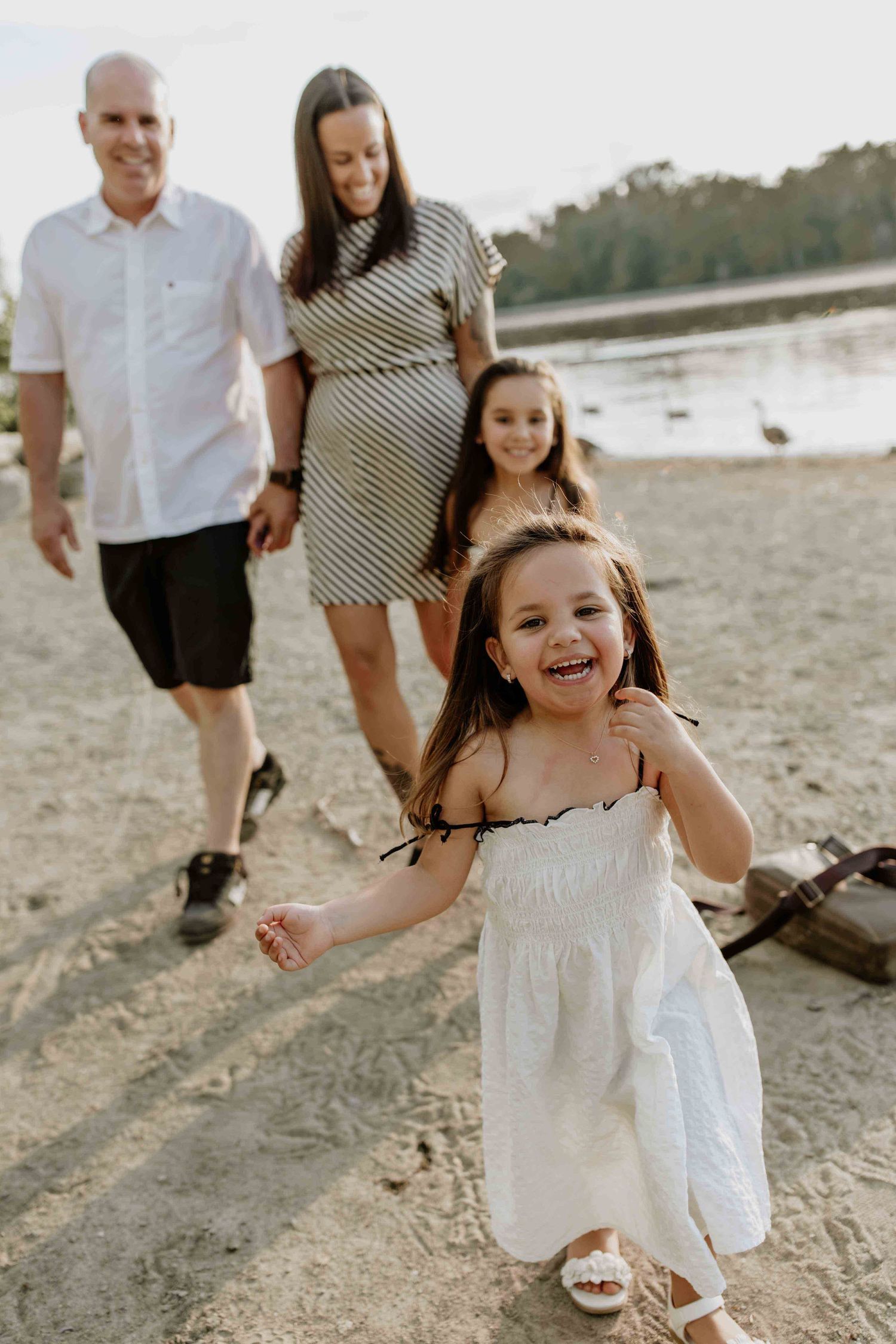 Family enjoying a beach day together during golden hour.