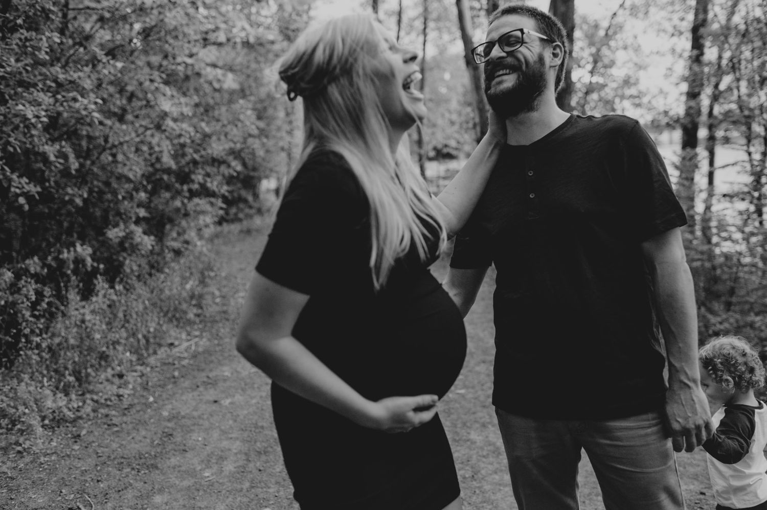 A romantic couple poses together in a black and white outdoor photoshoot series.