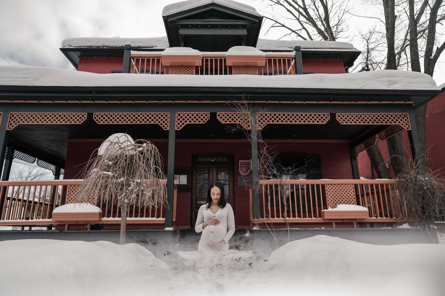 Architectural photos of a historic red building with white trim and balconies in winter.