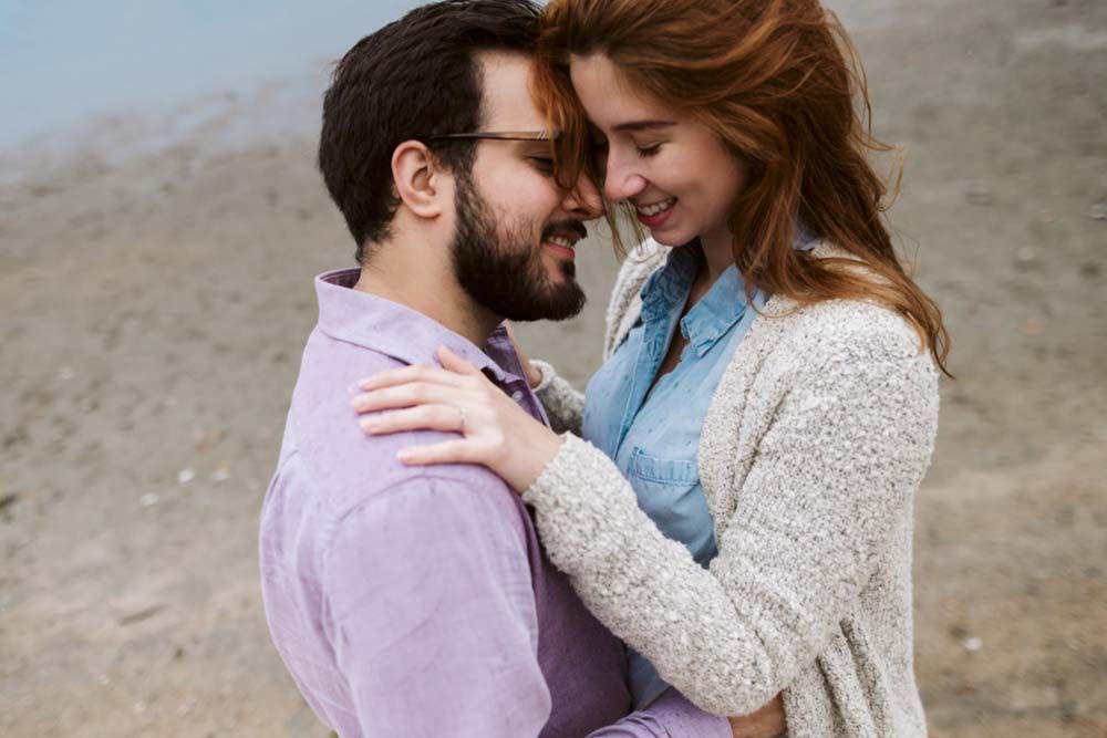 Sweet engagement photos of a couple in casual attire against a natural outdoor backdrop.