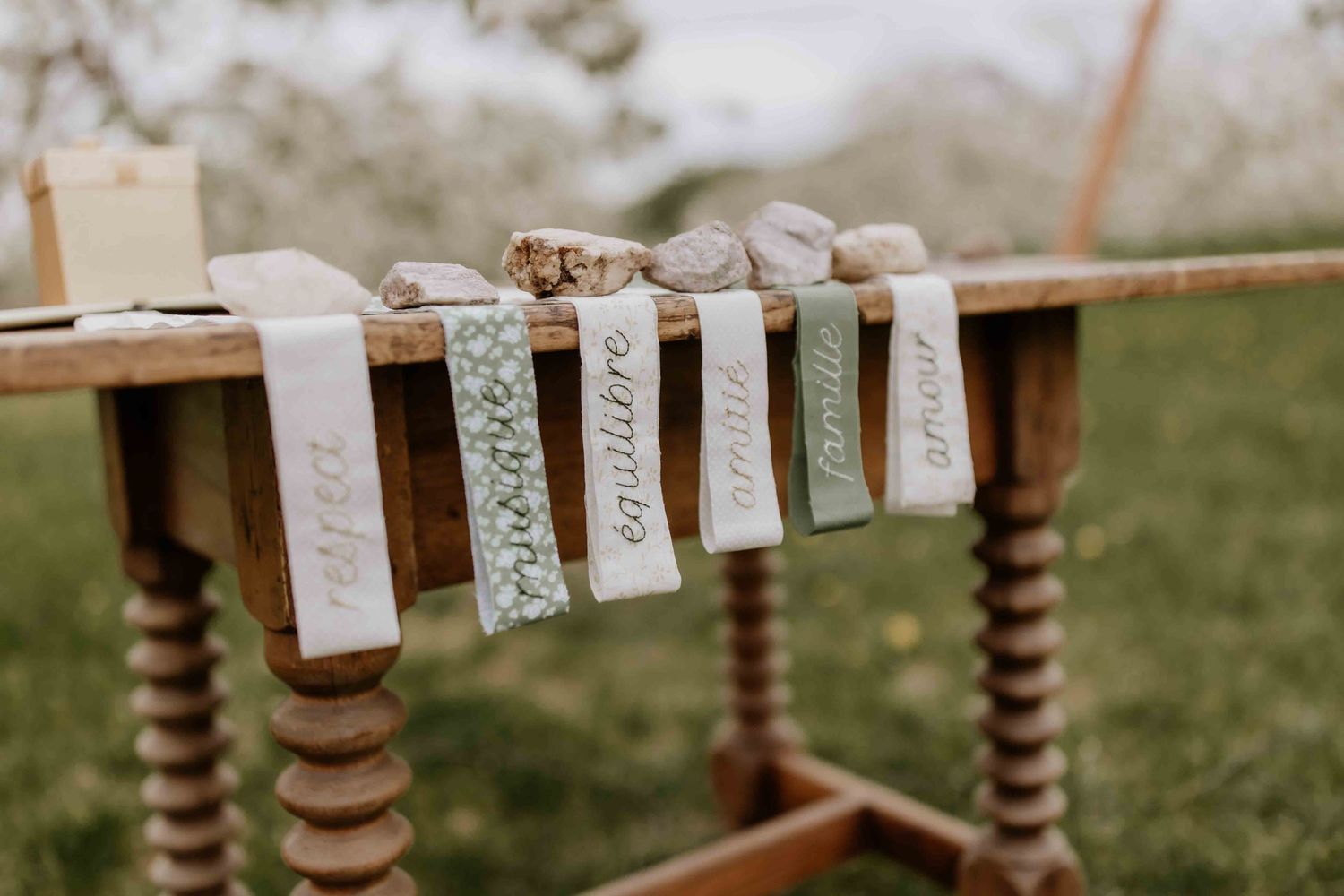 Rustic wedding decor featuring name cards hanging on twine with wooden details.