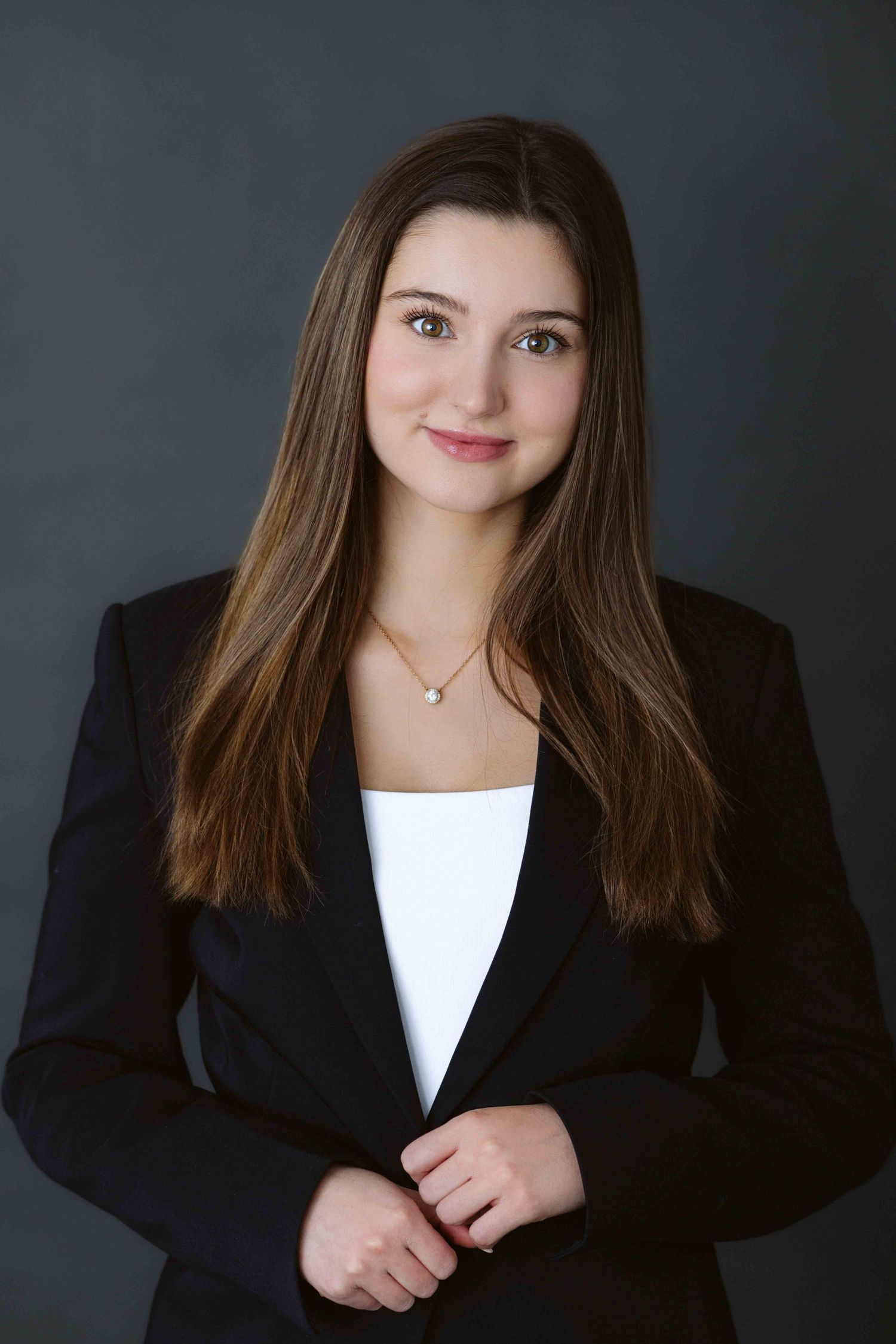 Professional headshots in business attire against dark background showing confident poses.