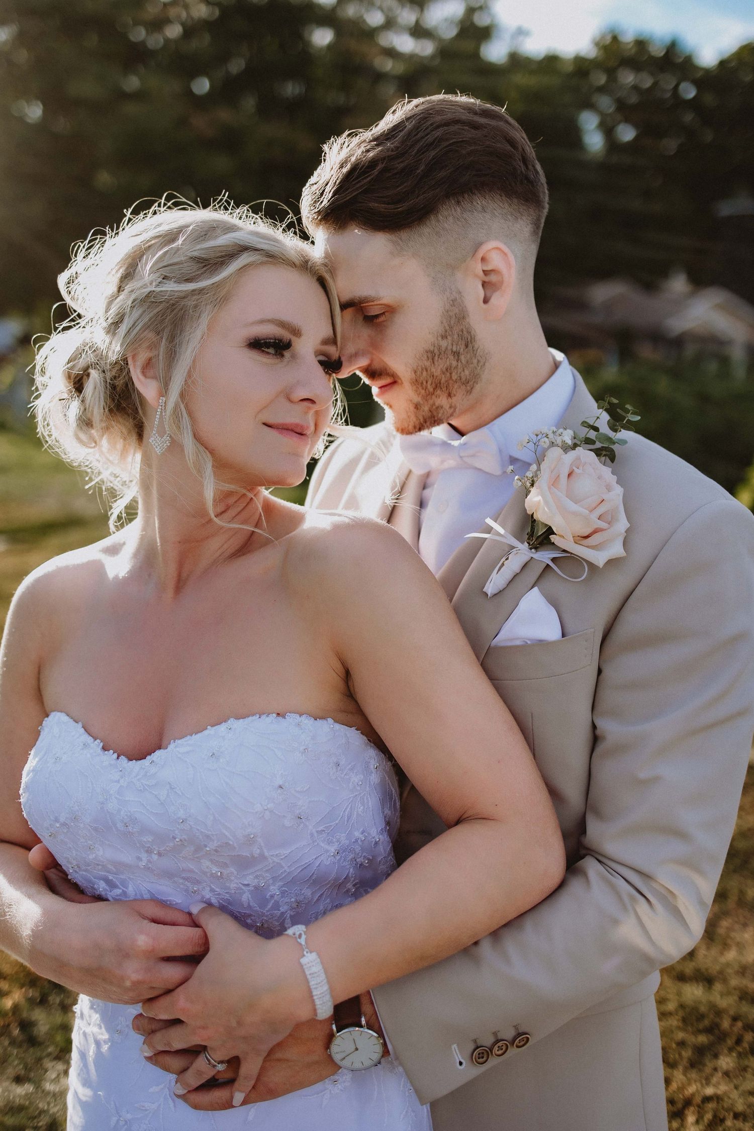 Tender wedding moment captured in golden afternoon light.