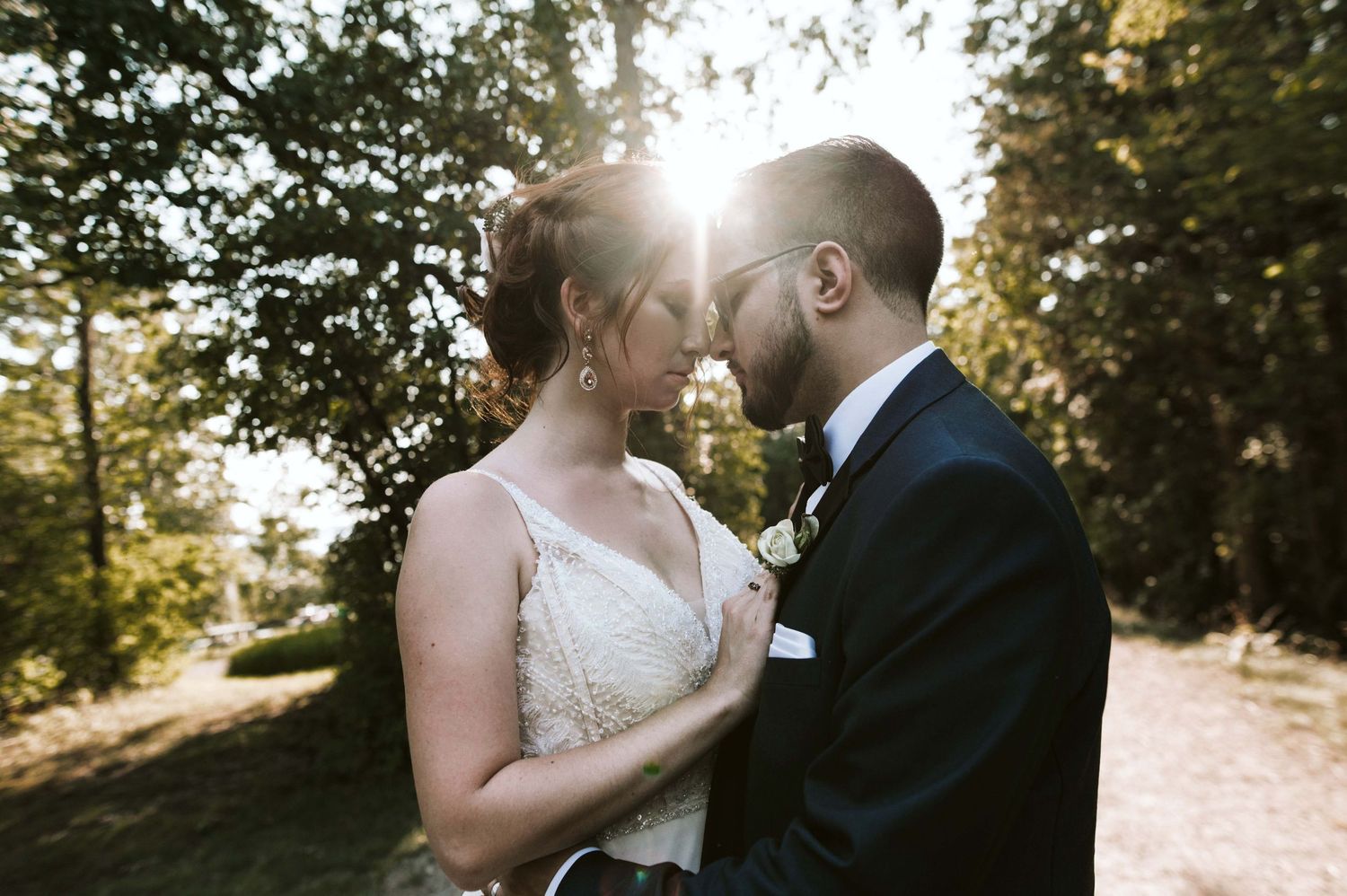 Romantic sunset wedding portrait in outdoor garden setting.