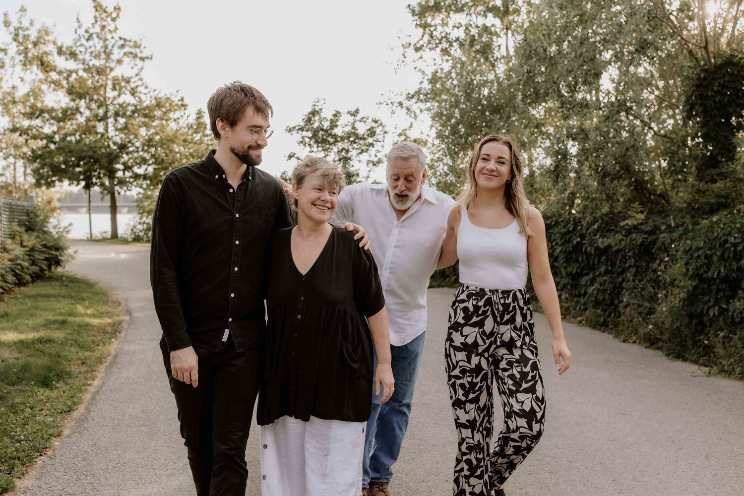 Group walking together on a paved path during golden hour.