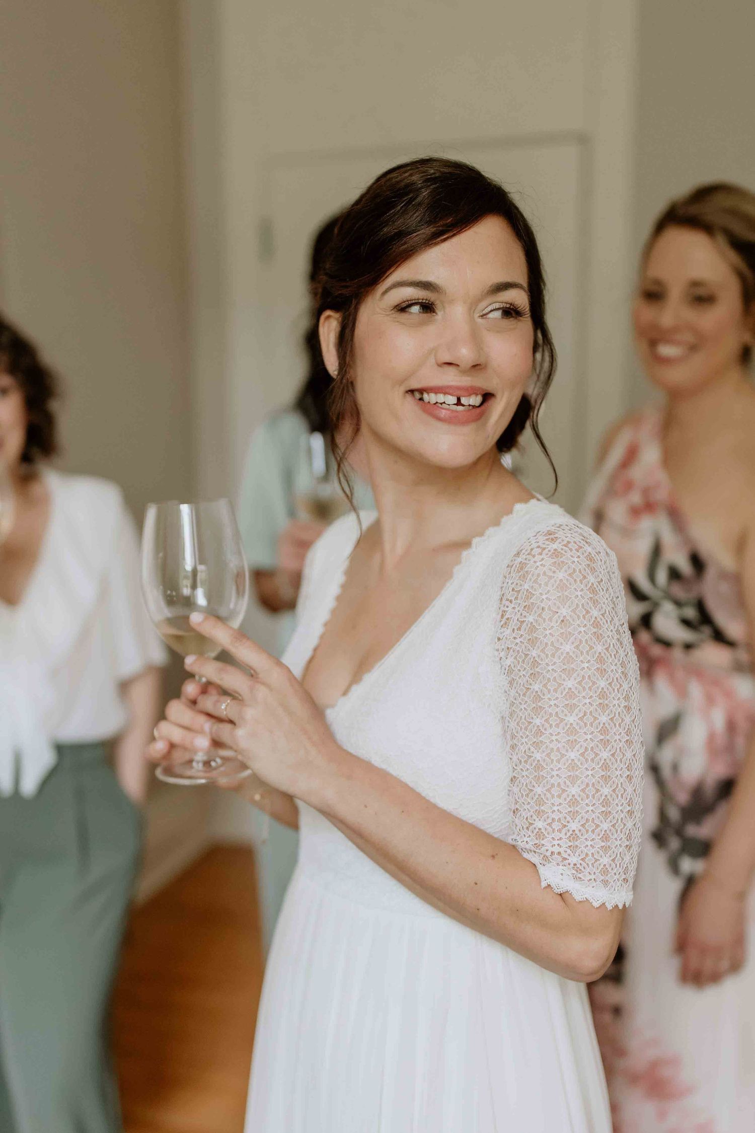 Wedding preparation scene with champagne glasses and lace details in natural light.