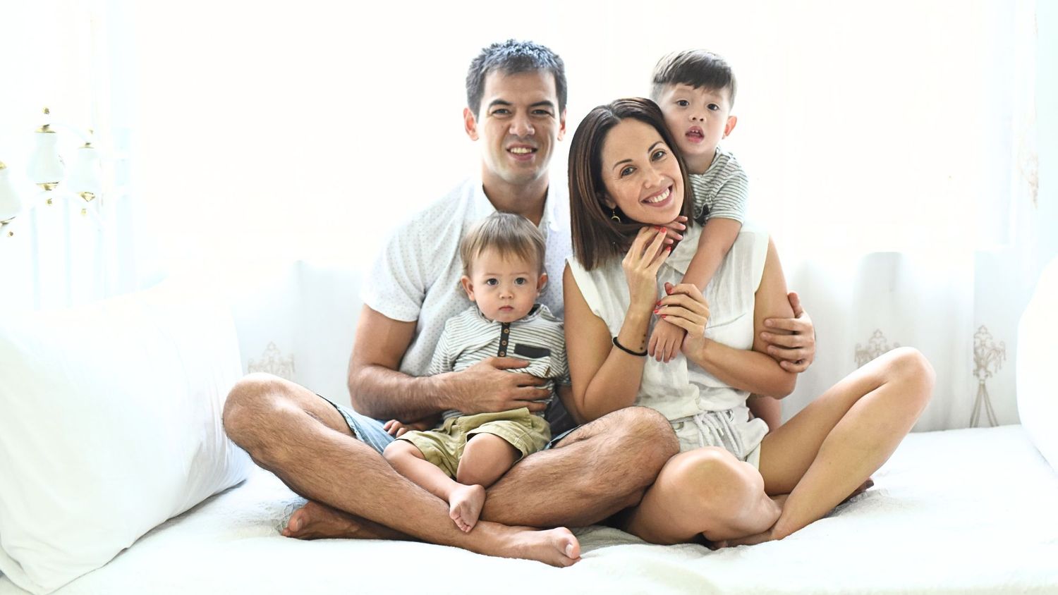 Story Road Studios Family Photography. Image of a dad, mom, and two young boys enjoying happy moment and everyone smiling.