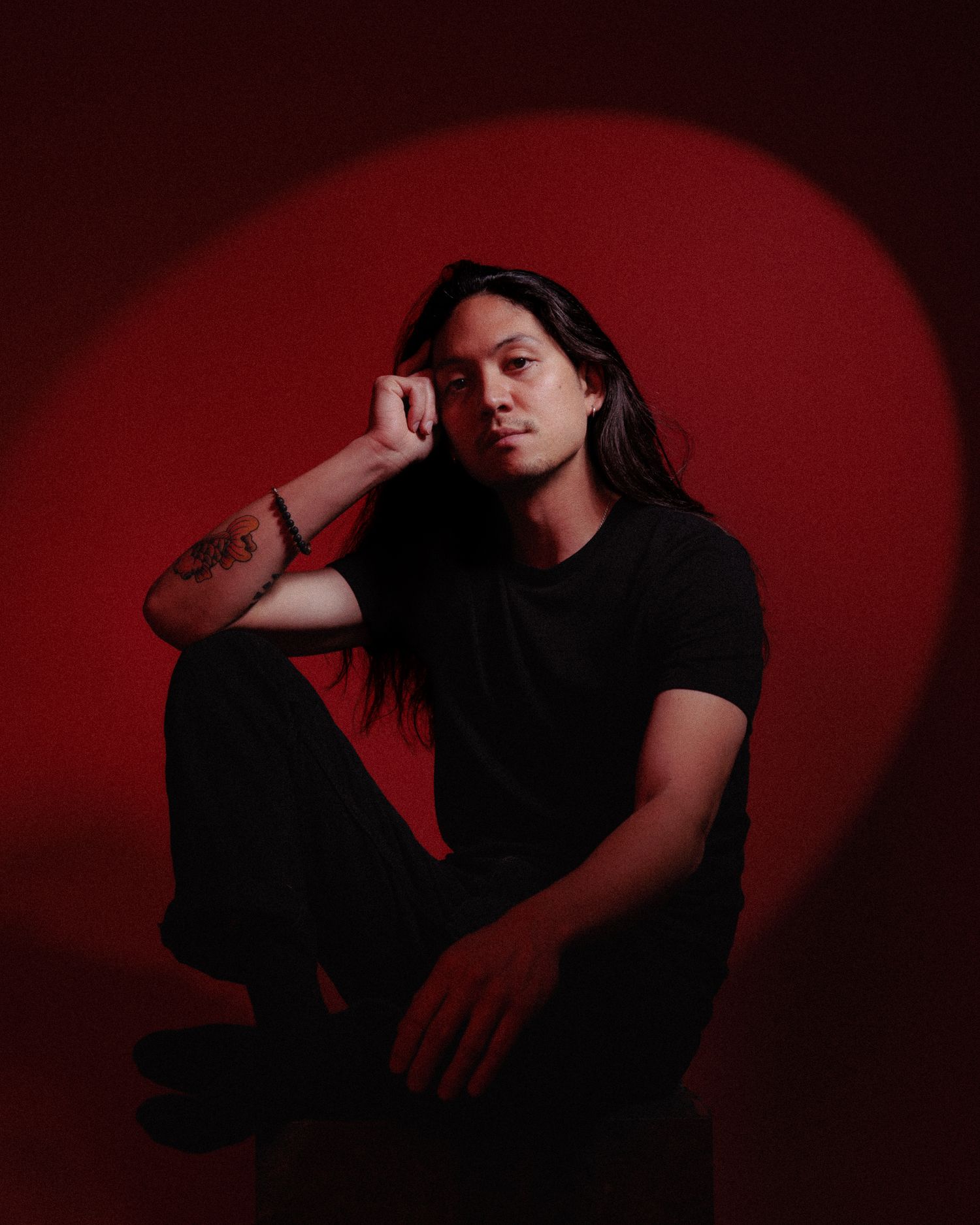 Atmospheric portrait series with dramatic red lighting and dark shadows.