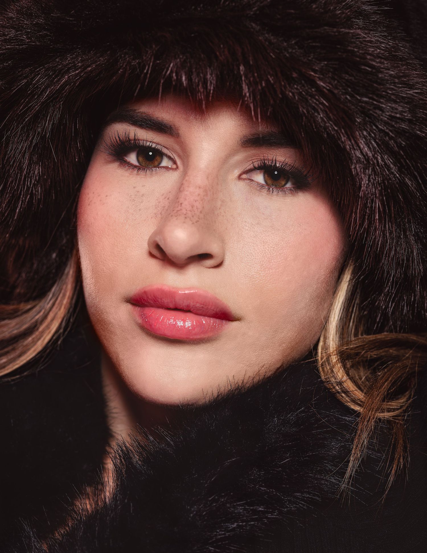 Close-up beauty shots with fur hat and dramatic makeup.