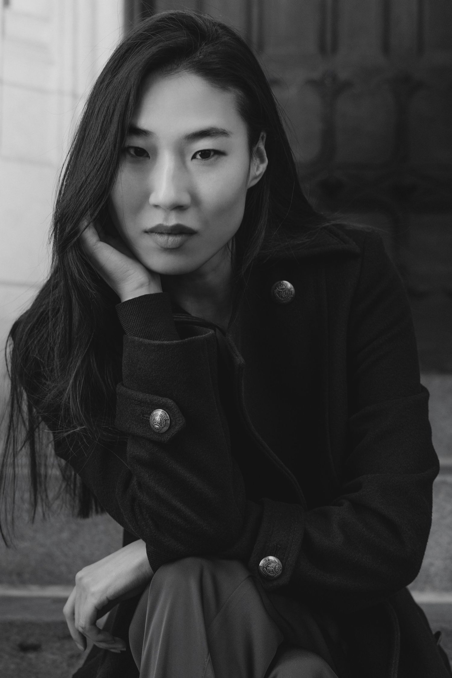 A black and white portrait series showing a person in a dark turtleneck sweater making different expressive poses.