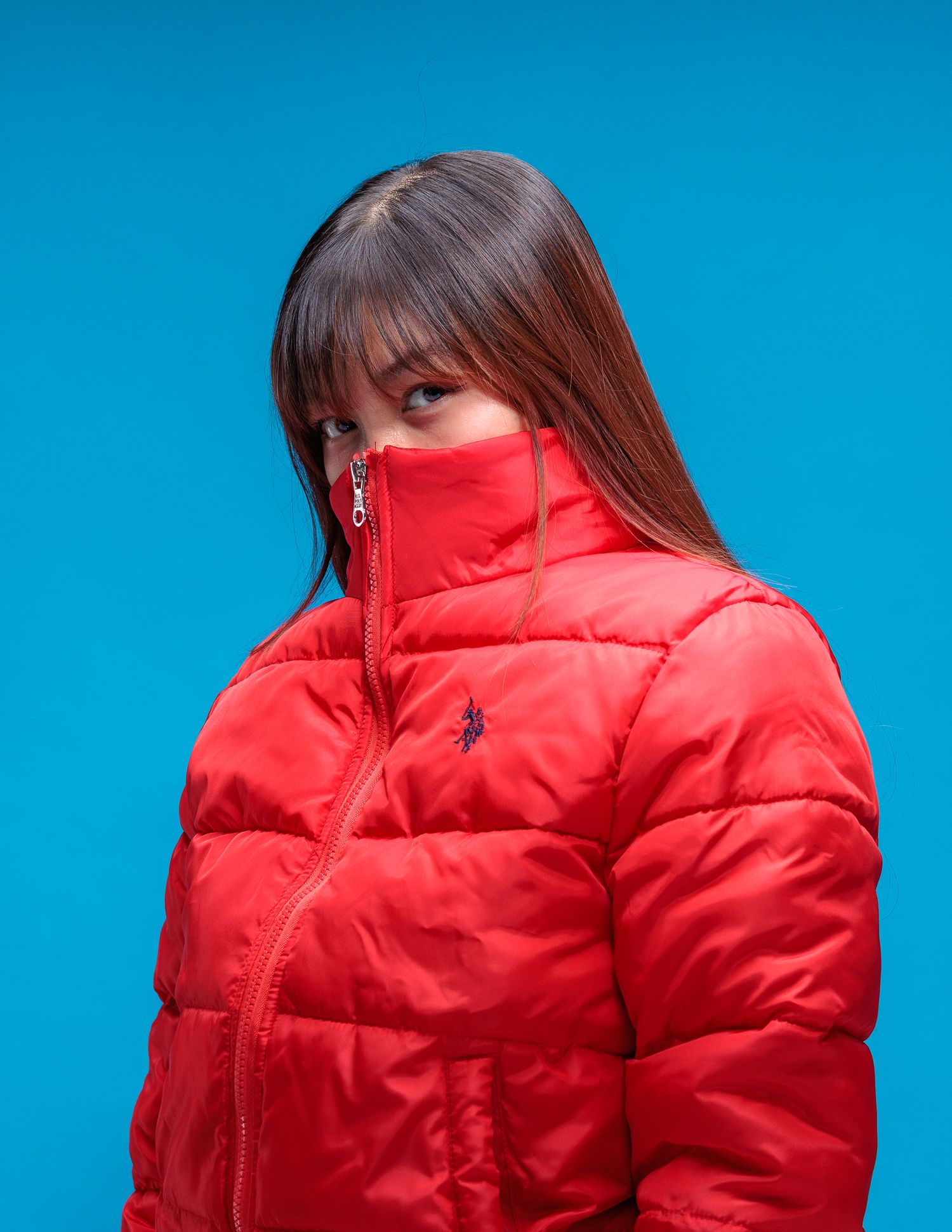 Red puffer jacket photographed against bright blue background in multiple angles.