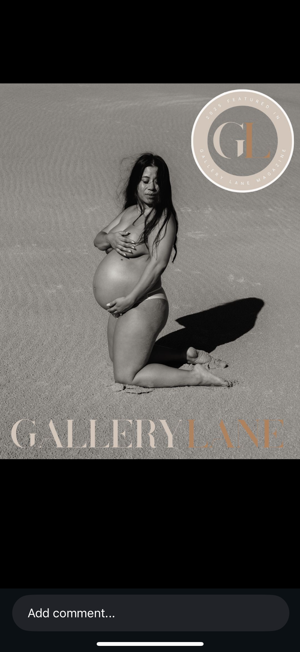 Woman kneeling in the sand at the dunes in Port Stephens holding her baby in her belly.