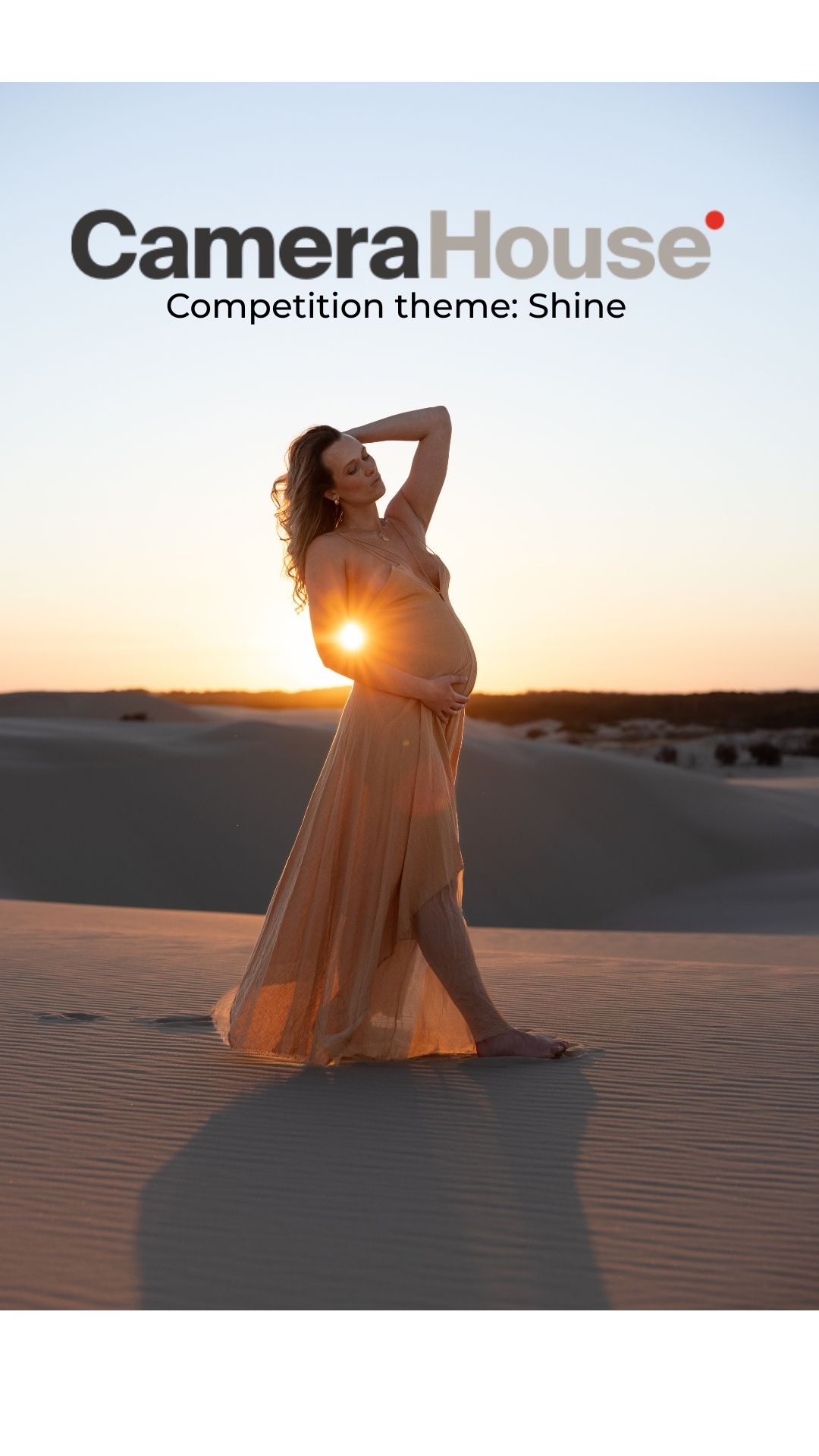 Pregnant mother stands bathed in golden sunset light.