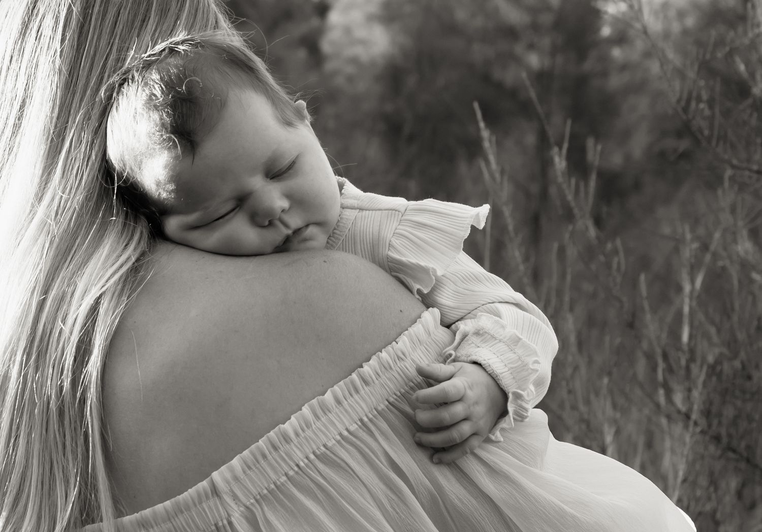 Baby rests head and sleeps on mother's shoulder in Newcastle.
