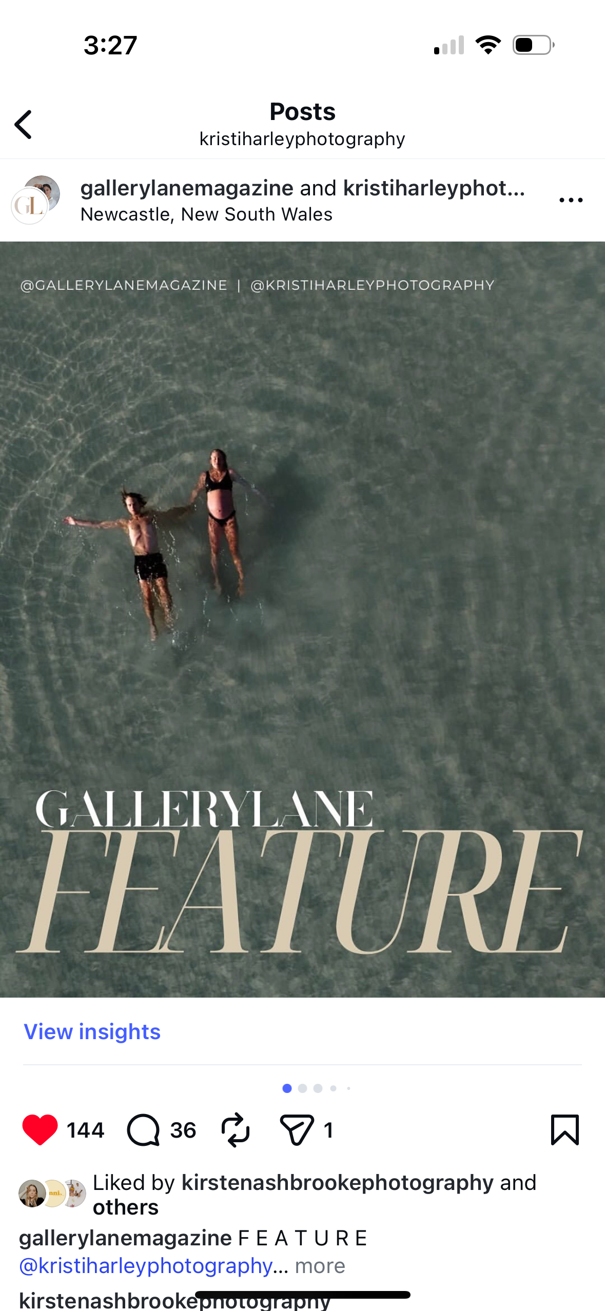 Mother and father float in the clam turquoise ocean waters in Newcastle captured from above by drone.