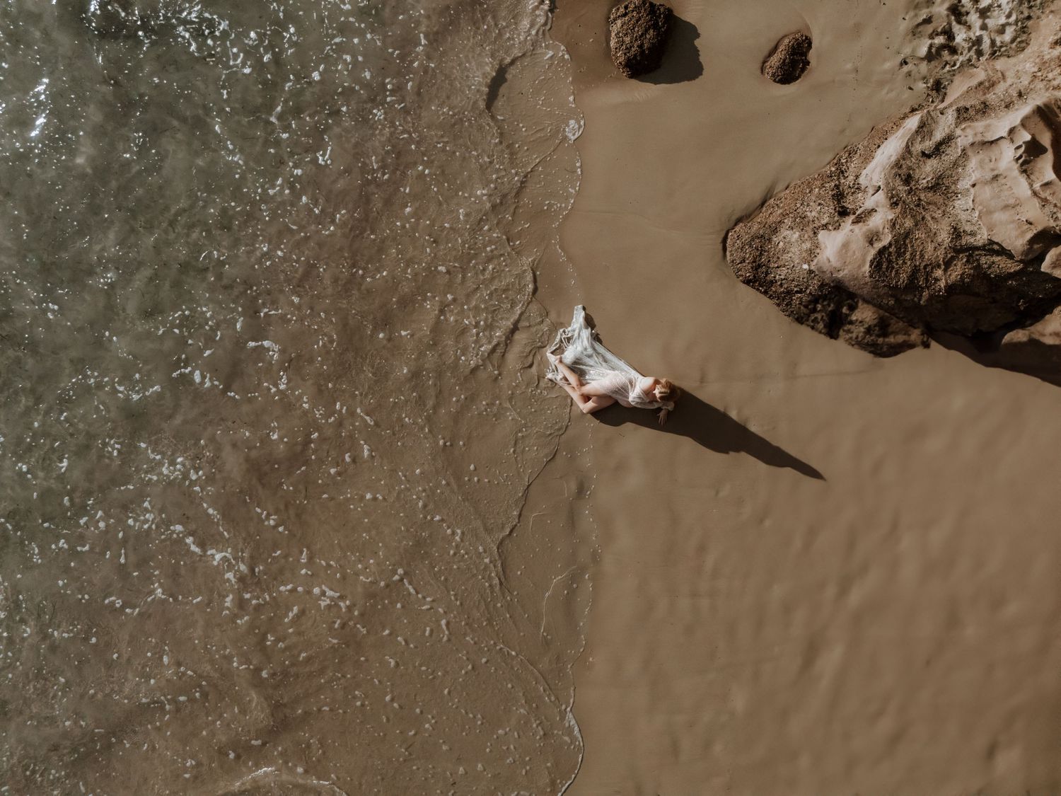 Maternity drone photography at the beach.