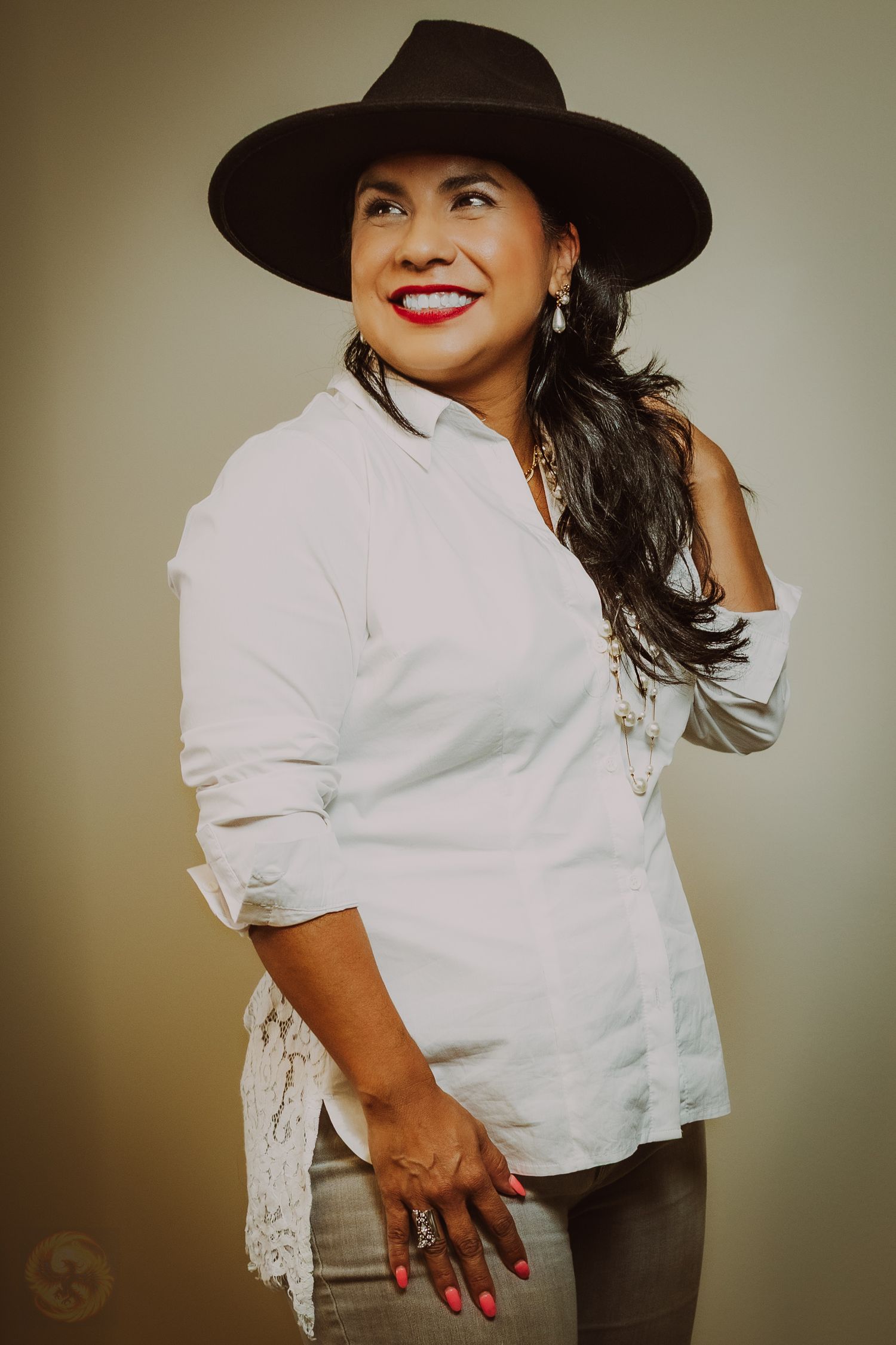 Fashion portraits featuring white lace blouse and black hat with dramatic lighting.