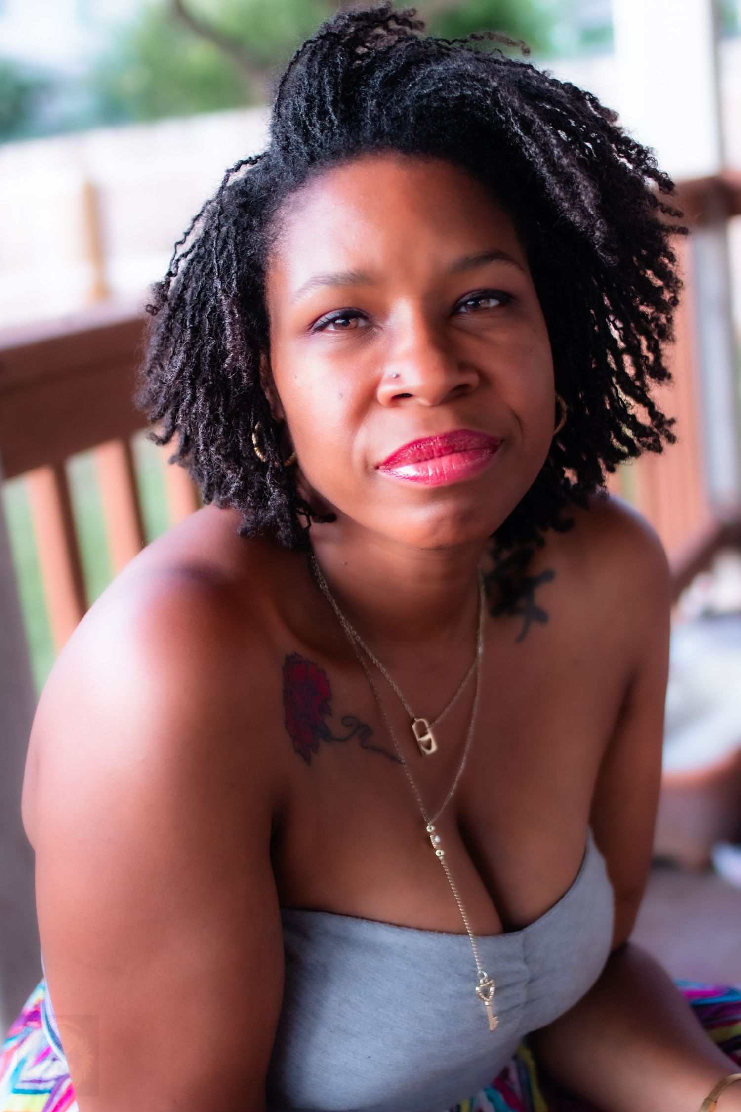 A casual portrait series showing natural curly hair and gray top against a light background.