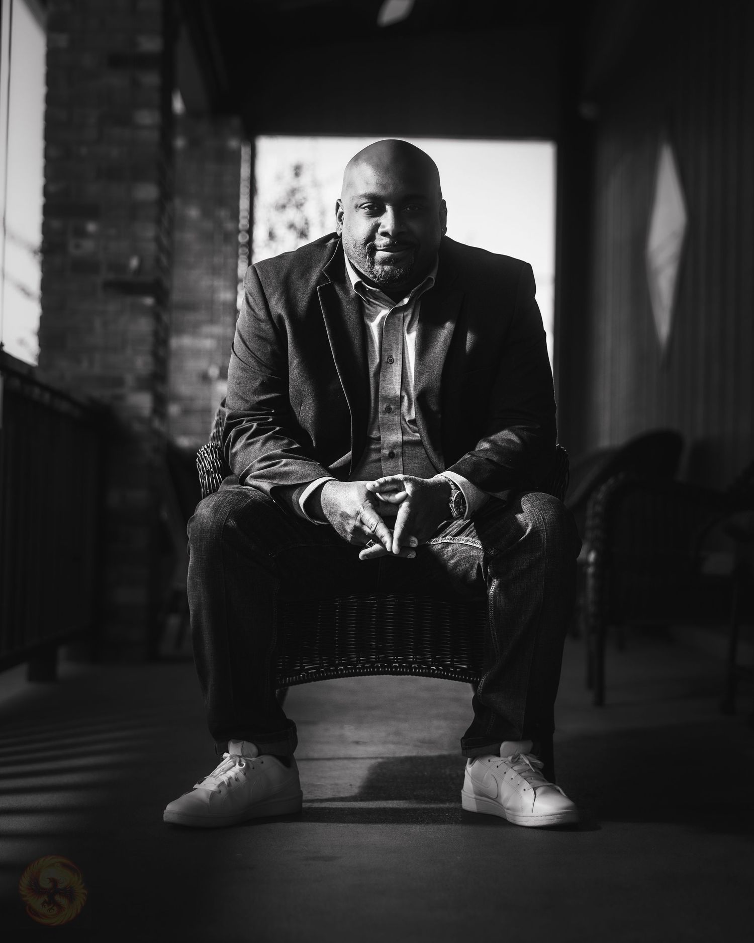 Dramatic black and white portrait series showing figure seated in dark room.