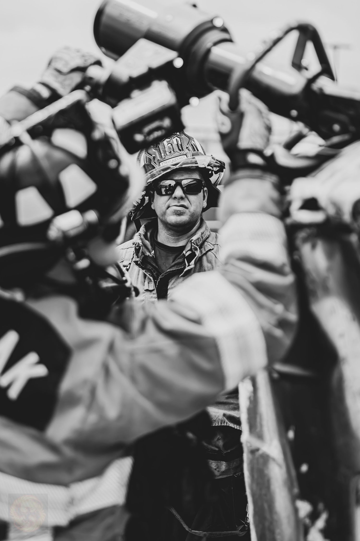 Black and white action shot of people wearing sunglasses.