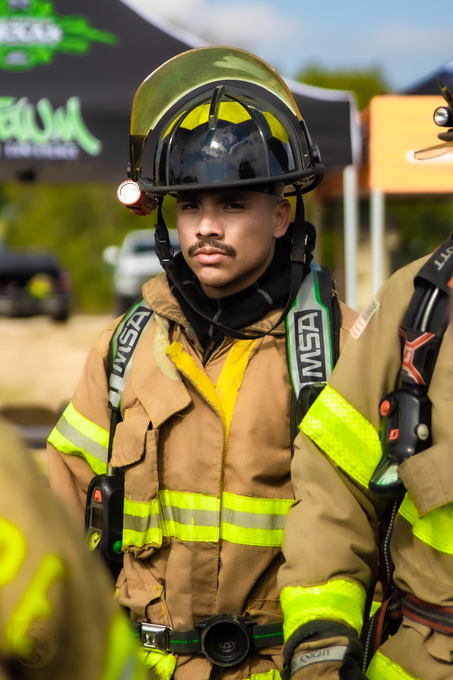 Firefighters in protective gear and high visibility uniforms standing in formation.