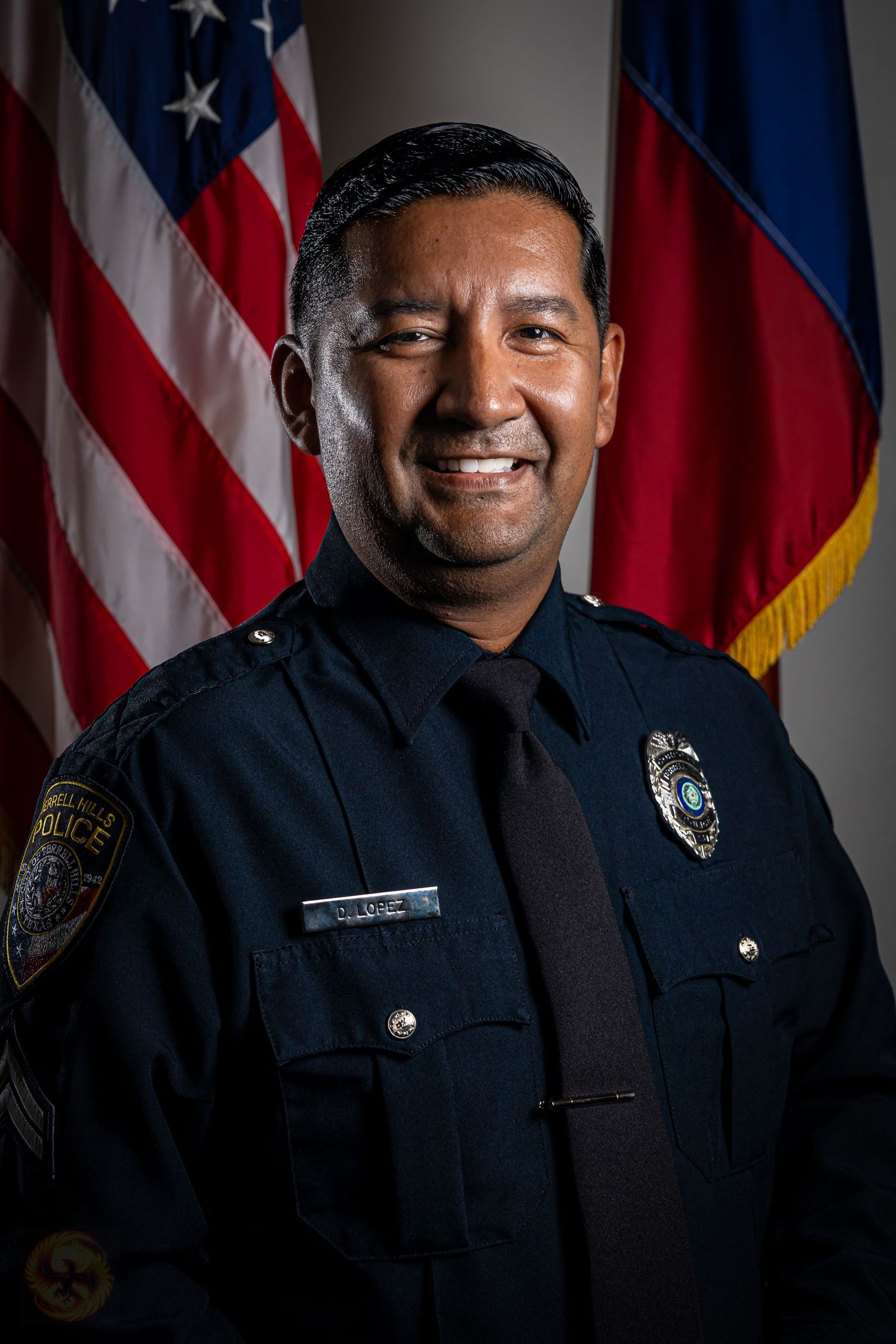 Professional portrait series of police officer in uniform with American flag background.