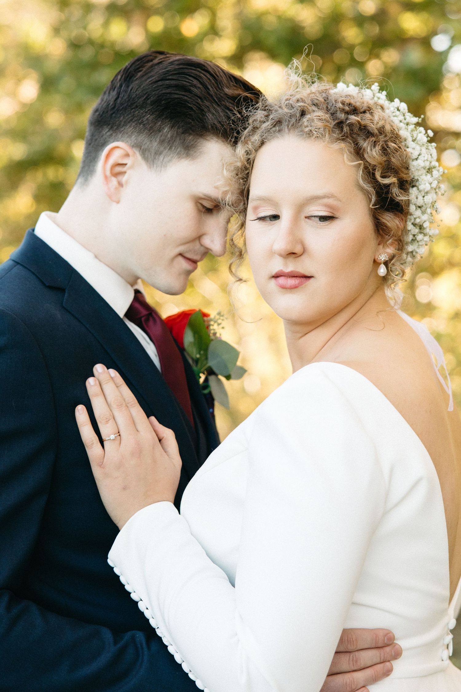 Intimate wedding portraits captured in warm golden sunlight showing tender romantic moments.