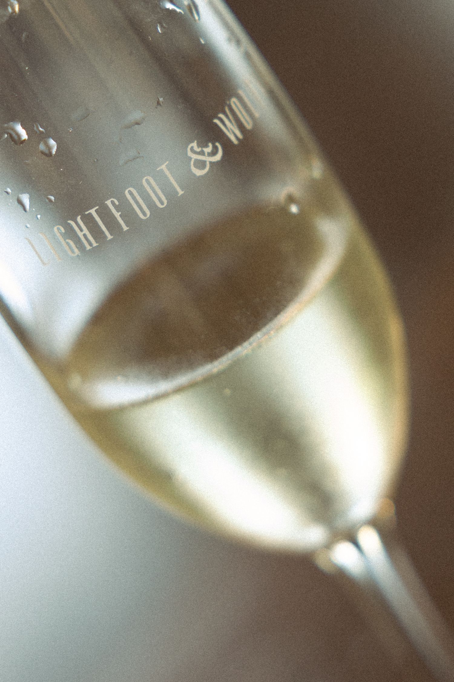 Champagne glasses filled with sparkling wine in soft focus.