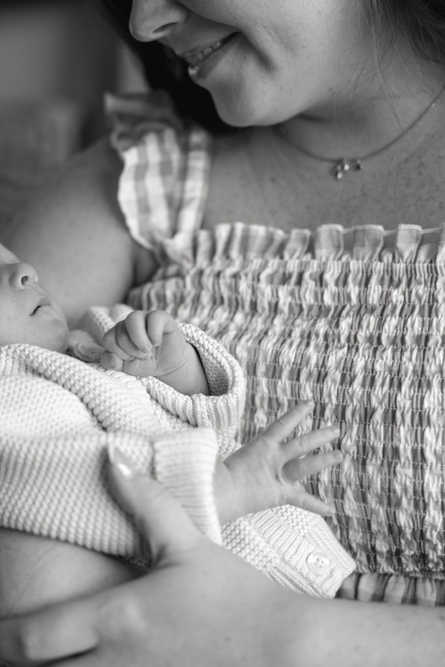 Close-up details of textured fabric and gentle embraces in black and white.