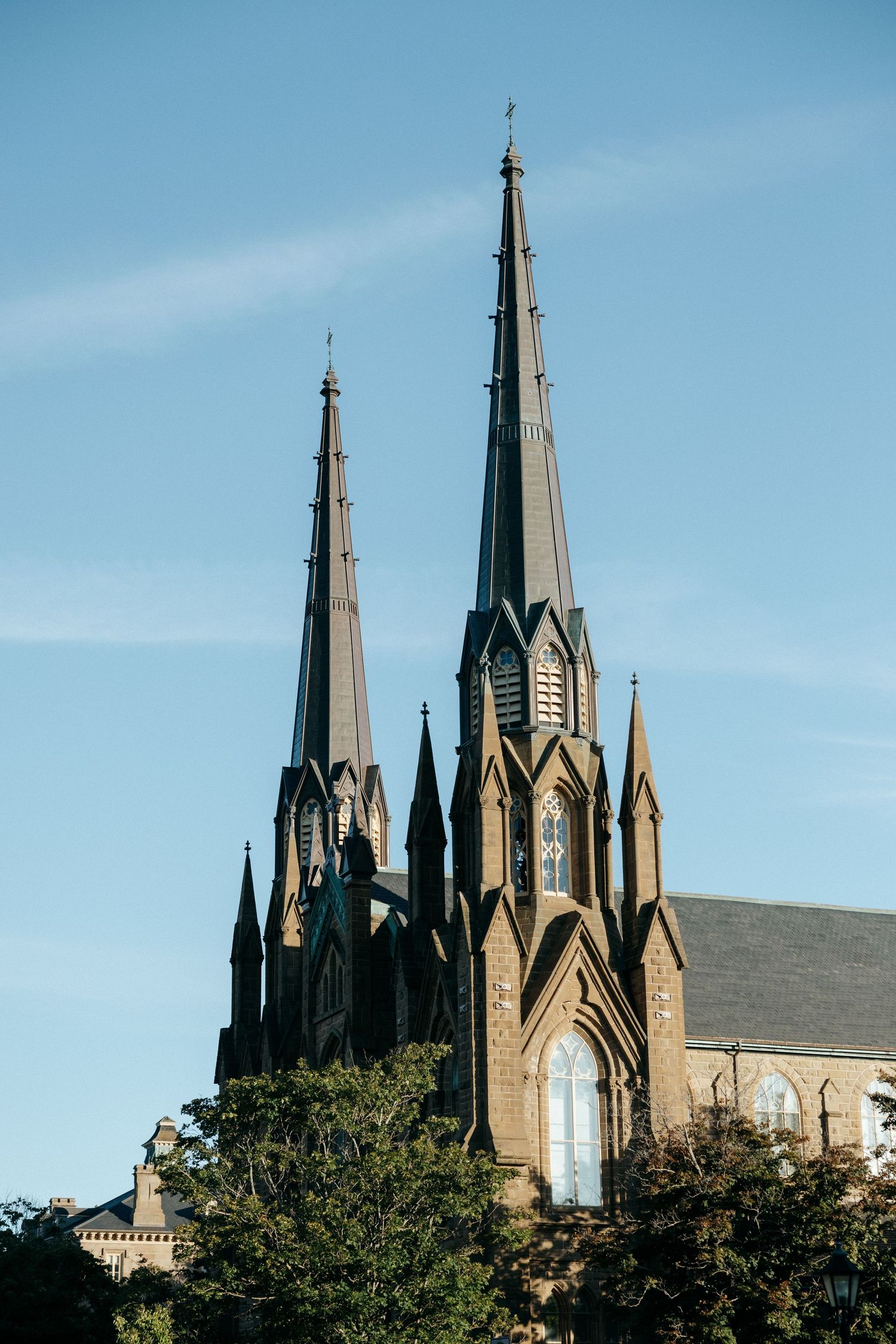 Gothic church spires rise against a bright blue sky.